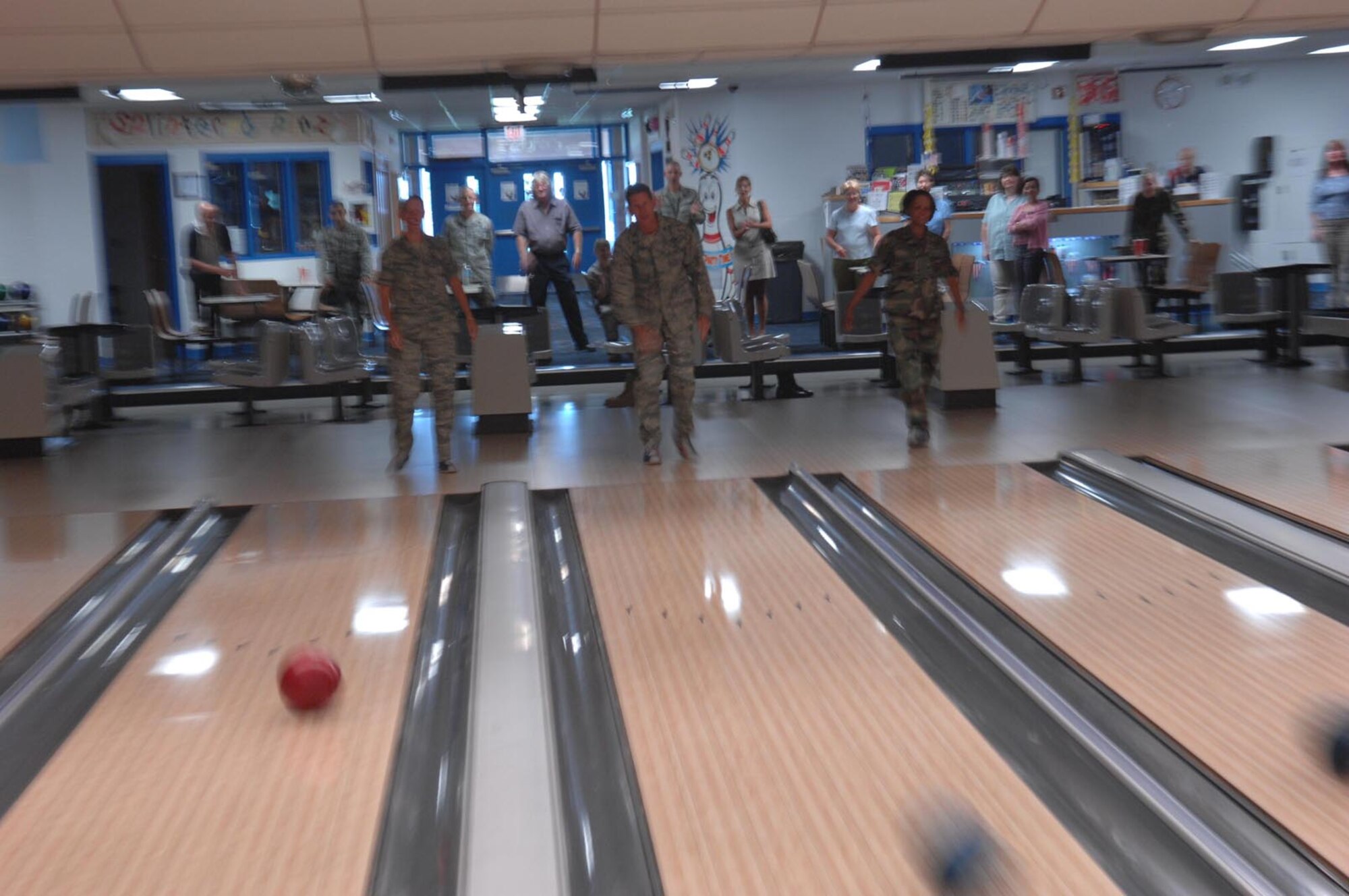 (Left) Maj. Launa Bellucci, 28th Force Support Squadron commander, Col. Peter Castor, 28th Bomb Wing vice commander, and Col. Renita D. Alexander, 28th Mission Support Group commander, bowl the first frame at the newly-renovated Bandit Lanes here July 23.  The 16 American Machine and Foundry 90 XLi Pinspotters allow for more fluid game play and use less energy to maintain; the renovations topped $254,000. (U.S. Air Force photo/Airman 1st Class Adam Grant) 


