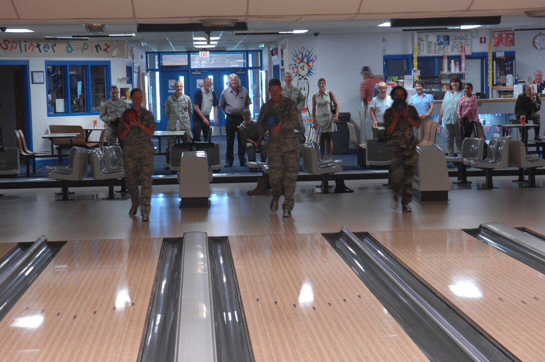 (Left) Maj. Launa Bellucci, 28th Force Support Squadron commander, Col. Peter Castor, 28th Bomb Wing vice commander, and Col. Renita D. Alexander, 28th Mission Support Group commander, bowl the first frame at the newly-renovated Bandit Lanes here July 23.  The 16 American Machine and Foundry 90 XLi Pinspotters allow for more fluid game play and use less energy to maintain; the renovations topped $254,000. (U.S. Air Force photo/Airman 1st Class Adam Grant) 


