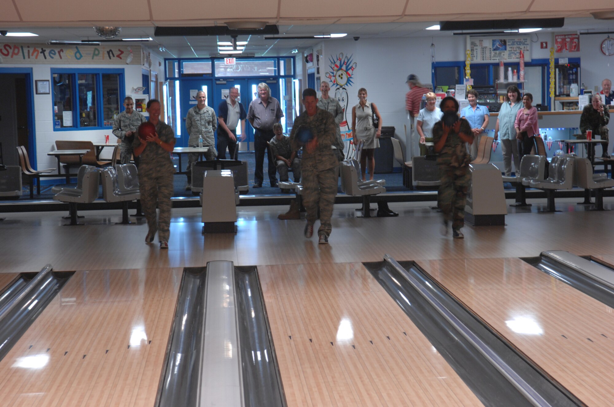 (Left) Maj. Launa Bellucci, 28th Force Support Squadron commander, Col. Peter Castor, 28th Bomb Wing vice commander, and Col. Renita D. Alexander, 28th Mission Support Group commander, bowl the first frame at the newly-renovated Bandit Lanes here July 23.  The 16 American Machine and Foundry 90 XLi Pinspotters allow for more fluid game play and use less energy to maintain; the renovations topped $254,000. (U.S. Air Force photo/Airman 1st Class Adam Grant) 


