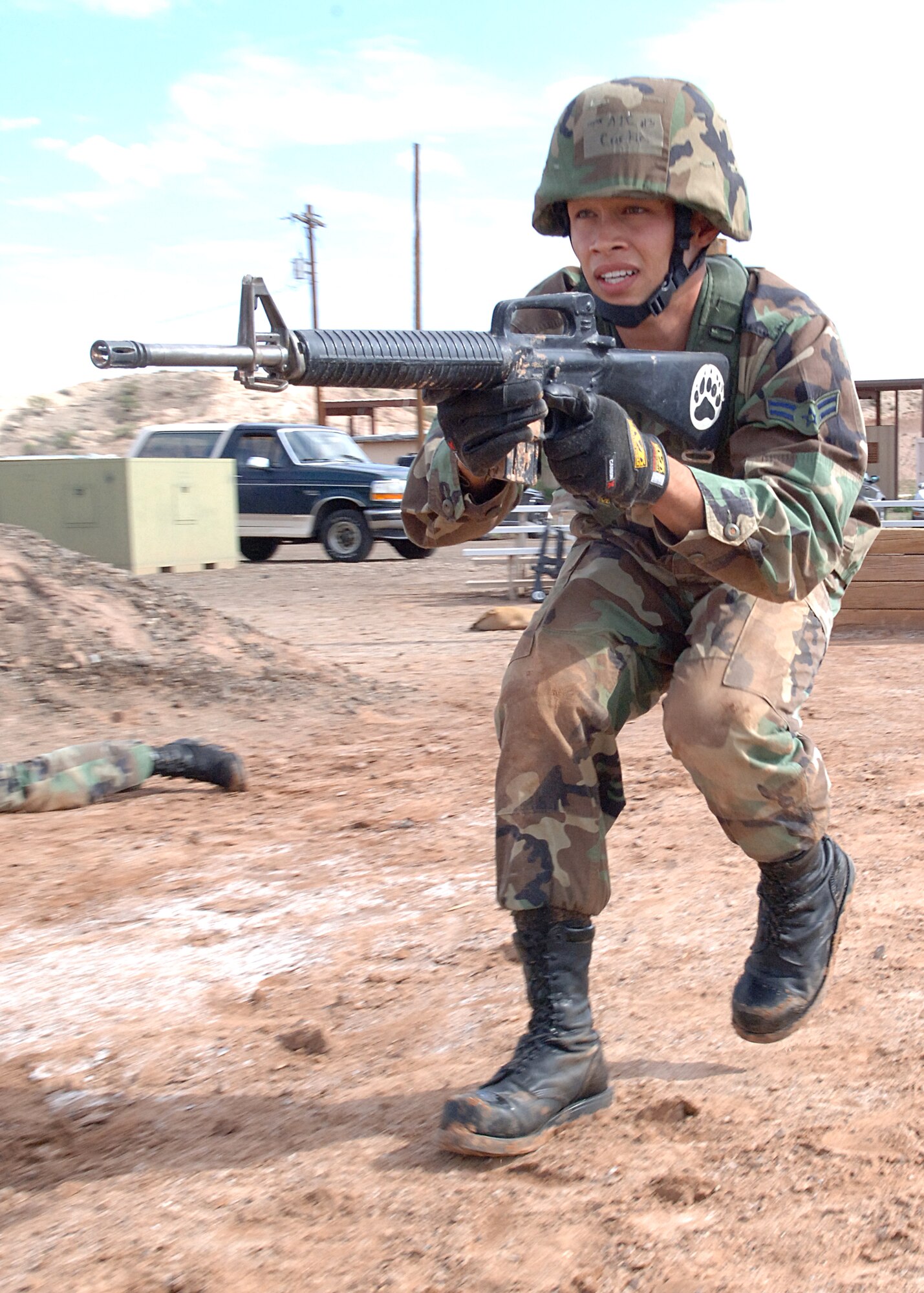 Airman 1st Class Michael Curtin, 49th Materiel Maintenance Squadron, moves into position during an exercise at the Combat Skills Training Course at Holloman Air Force Base, N.M., July 22.  The Combat Skills Training Course is a 19 hour course that consists of pre-deployment training and combat tactical skills training.  (U.S. Air Force photo/Airman 1st Class John Strong)