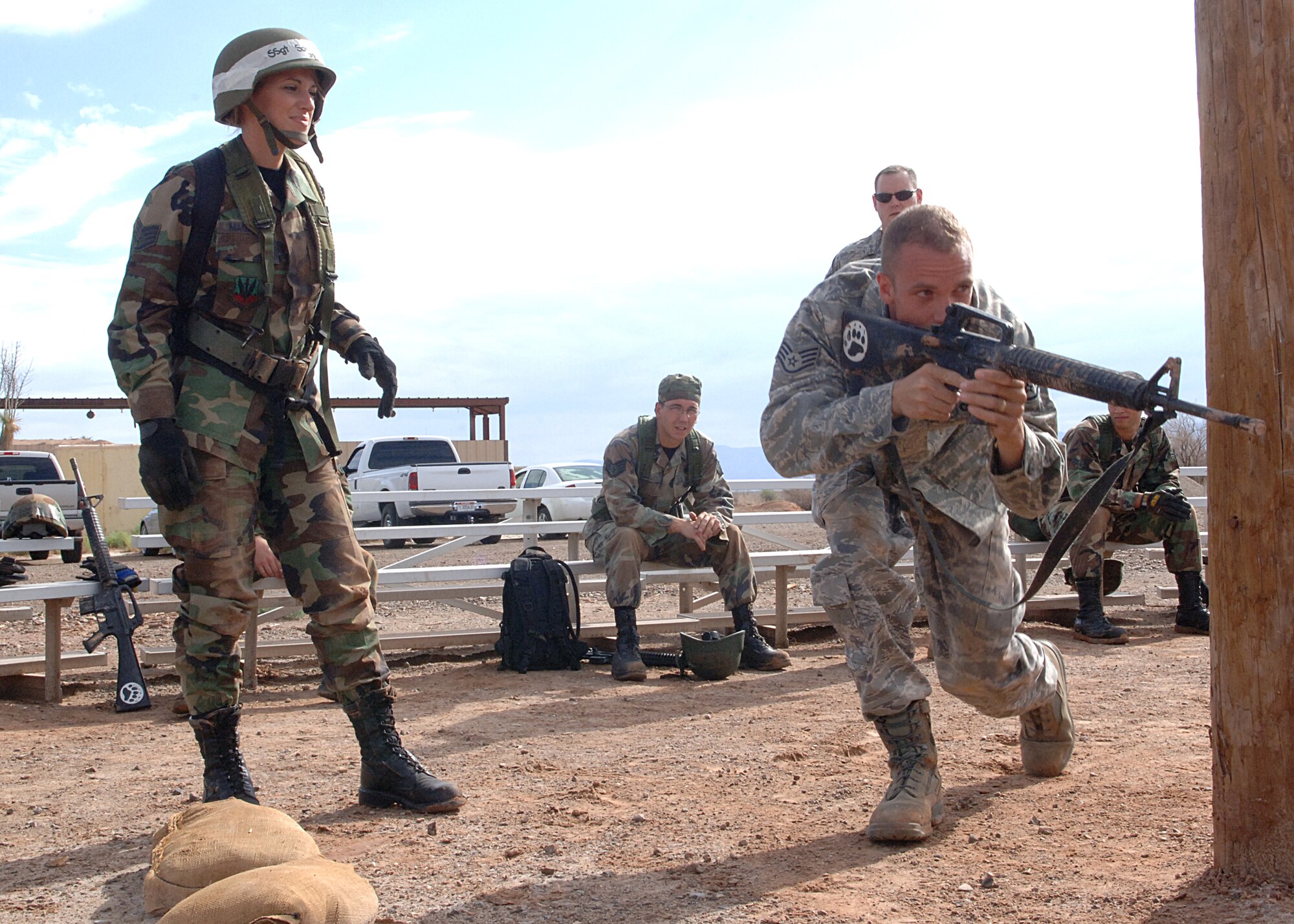 Staff Sgt. Jason Broadaway, 49th Security Forces Squadron, demonstrates how to properly come from behind cover during the Combat Skills Training Course at Holloman Air Force Base, N.M., July 22.  The Combat Skills Training Course is a 19 hour course that consists of pre-deployment training and combat tactical skills training.  (U.S. Air Force photo/Airman 1st Class John Strong)