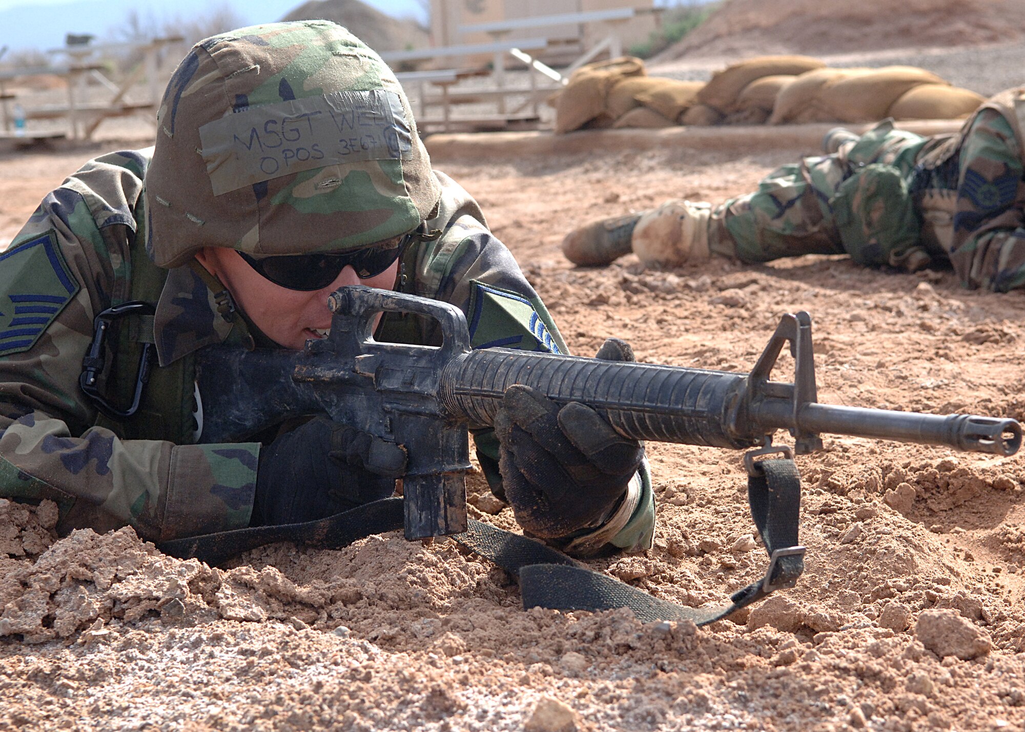 Master Sgt. Michal Wells, 49th Materiel Maintenance Squadron, provides cover for his partner during a training exercise at the Combat Skills Training Course at Holloman Air Force Base, N.M., July 22.  The Combat Skills Training Course is a 19 hour course that consists of pre-deployment training and combat tactical skills training.  (U.S. Air Force photo/Airman 1st Class John Strong)    
