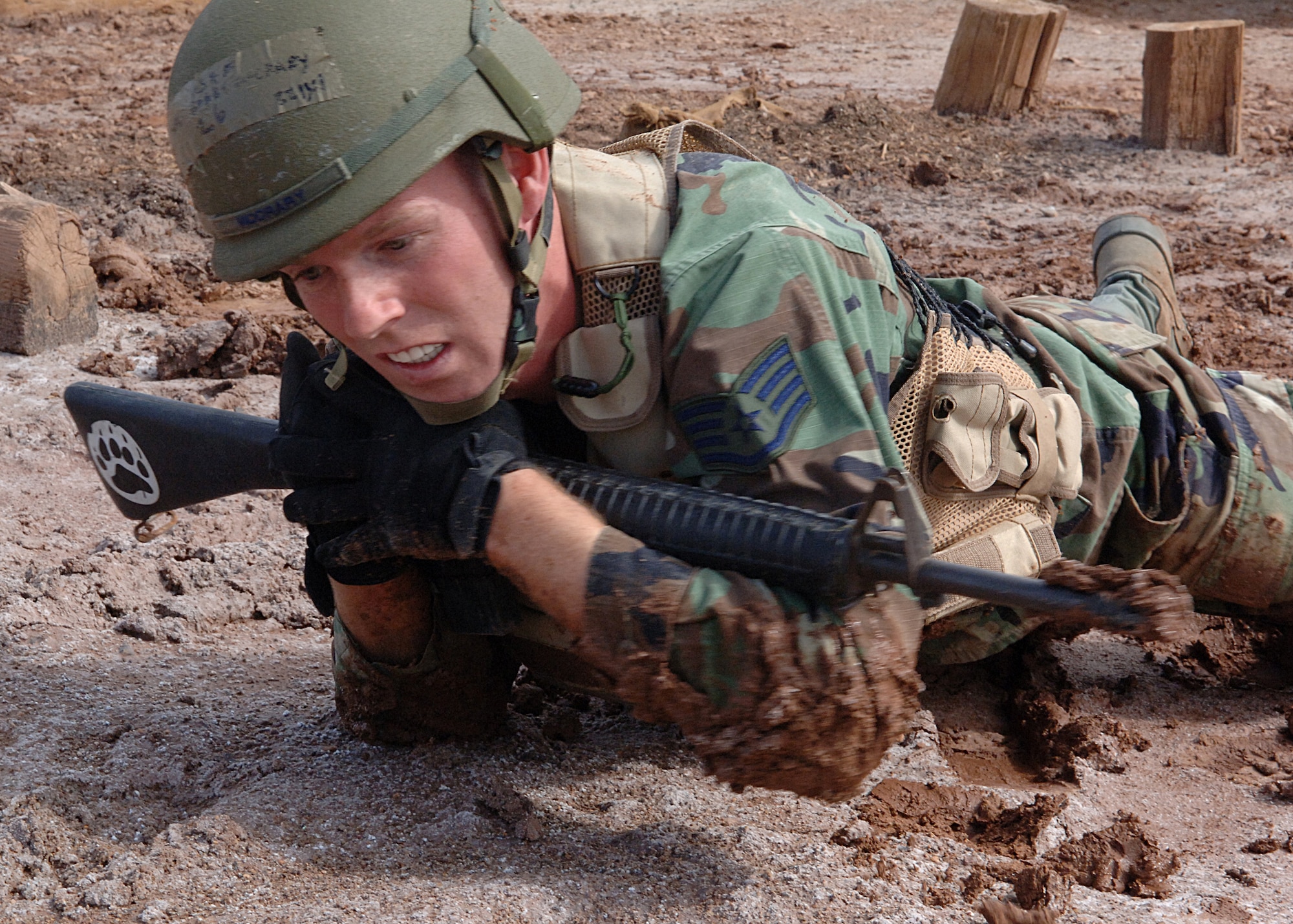 Staff Sgt. Bobby McCrary, 49th Materiel Maintenance Squadron, high crawls through the mud during an exercise at the Combat Skills Training Course at Holloman Air Force Base, N.M., July 22.  The Combat Skills Training Course is a 19 hour course that consists of pre-deployment training and combat tactical skills training.  (U.S. Air Force photo/Airman 1st Class John Strong)