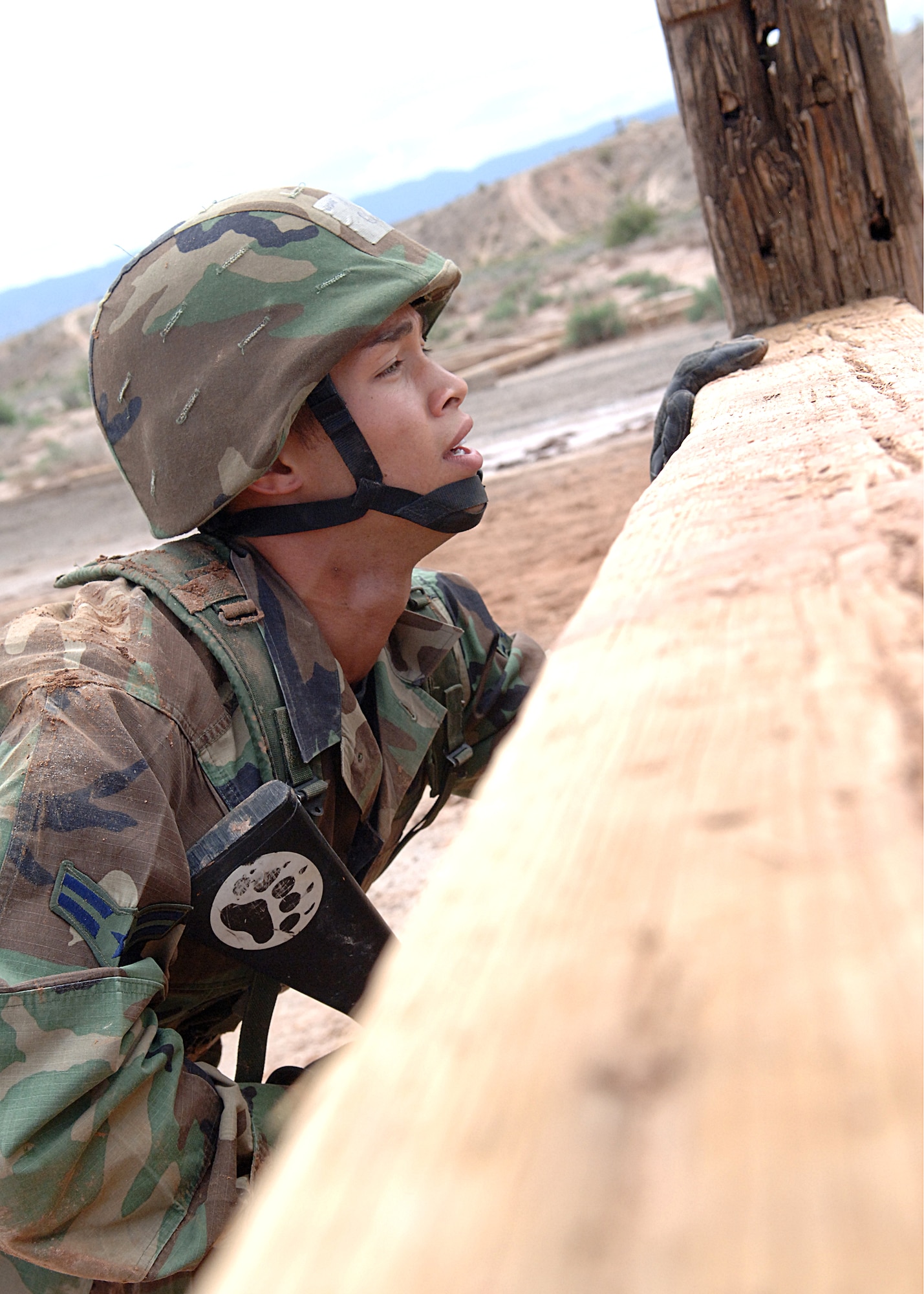 Airman 1st Class Michael Curtin, 49th Materiel Maintenance Squadron, peeks over a wall before hoping over it during an exercise at the Combat Skills Training Course on Holloman Air Force Base, N.M., July 22.  The Combat Skills Training Course is a 19 hour course that consists of pre-deployment training and combat tactical skills training.  (U.S. Air Force photo/Airman 1st Class John Strong)
