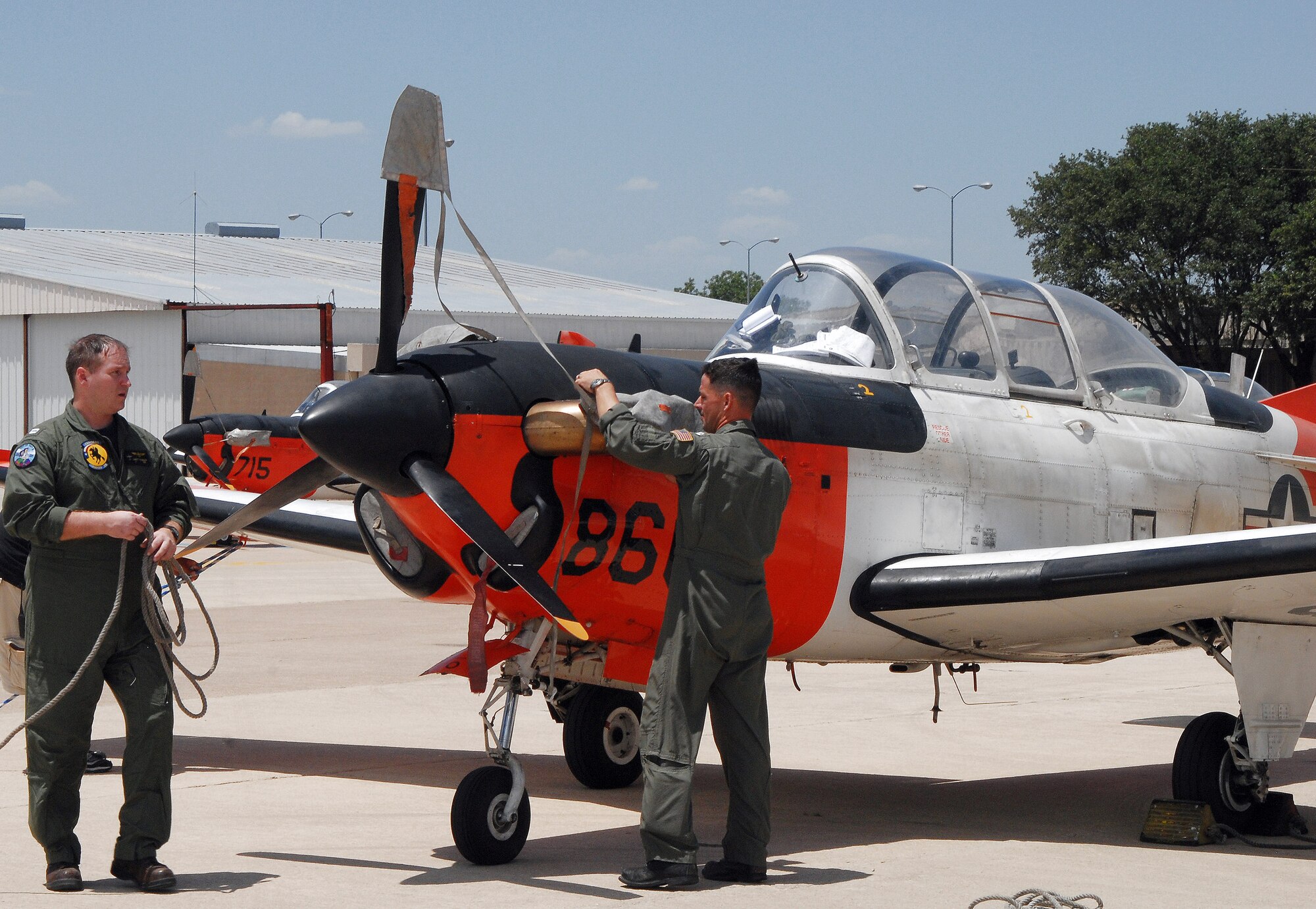 Navy pilots bed down a T-34 trainer aircraft July 22 at Mathis Field Airport in San Angelo, Texas.  Twenty-three aircraft were sent from Corpus Christi Naval Air Station to Mathis Field, their designated inland airport, to escape potential damage from Hurricane Dolly. (U.S. Air Force photo/Paul R. Martin)