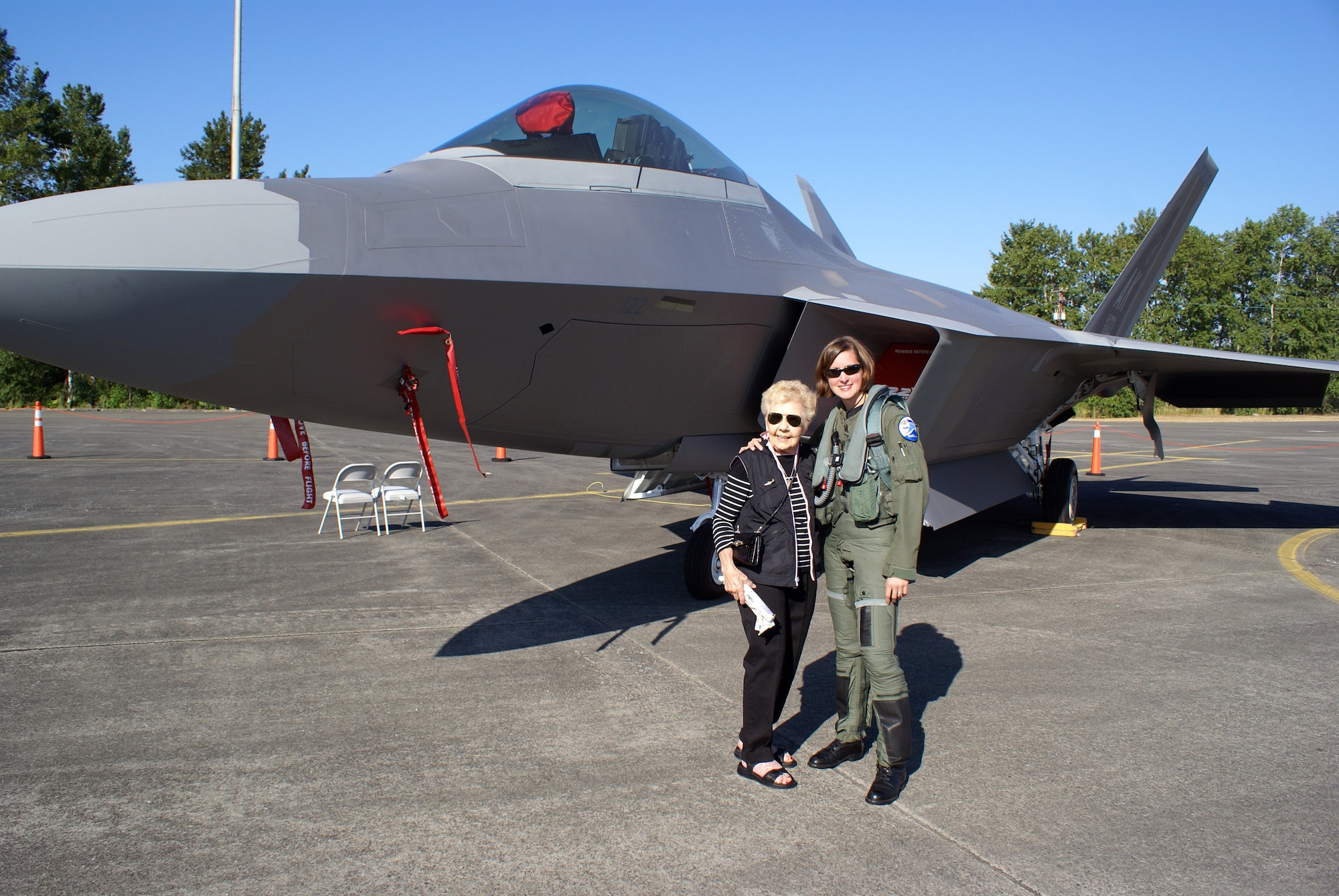 Dorothy Olsen meets with Capt. Jammie Jamieson during the July 20 airshow at McChord Air Force Base, Wash. Captain Jamieson, currently stationed at Elmendorf Air Force Base, Alaska, is the mobility flight commander for the 525th Fighter Squadron. She is the first operational and combat-ready female F-22 Raptor pilot. Ms. Olsen is a former member of the a former Women Airforce Service Pilots. (U.S. Air Force photo/Staff Sgt. Eric Burks) 
