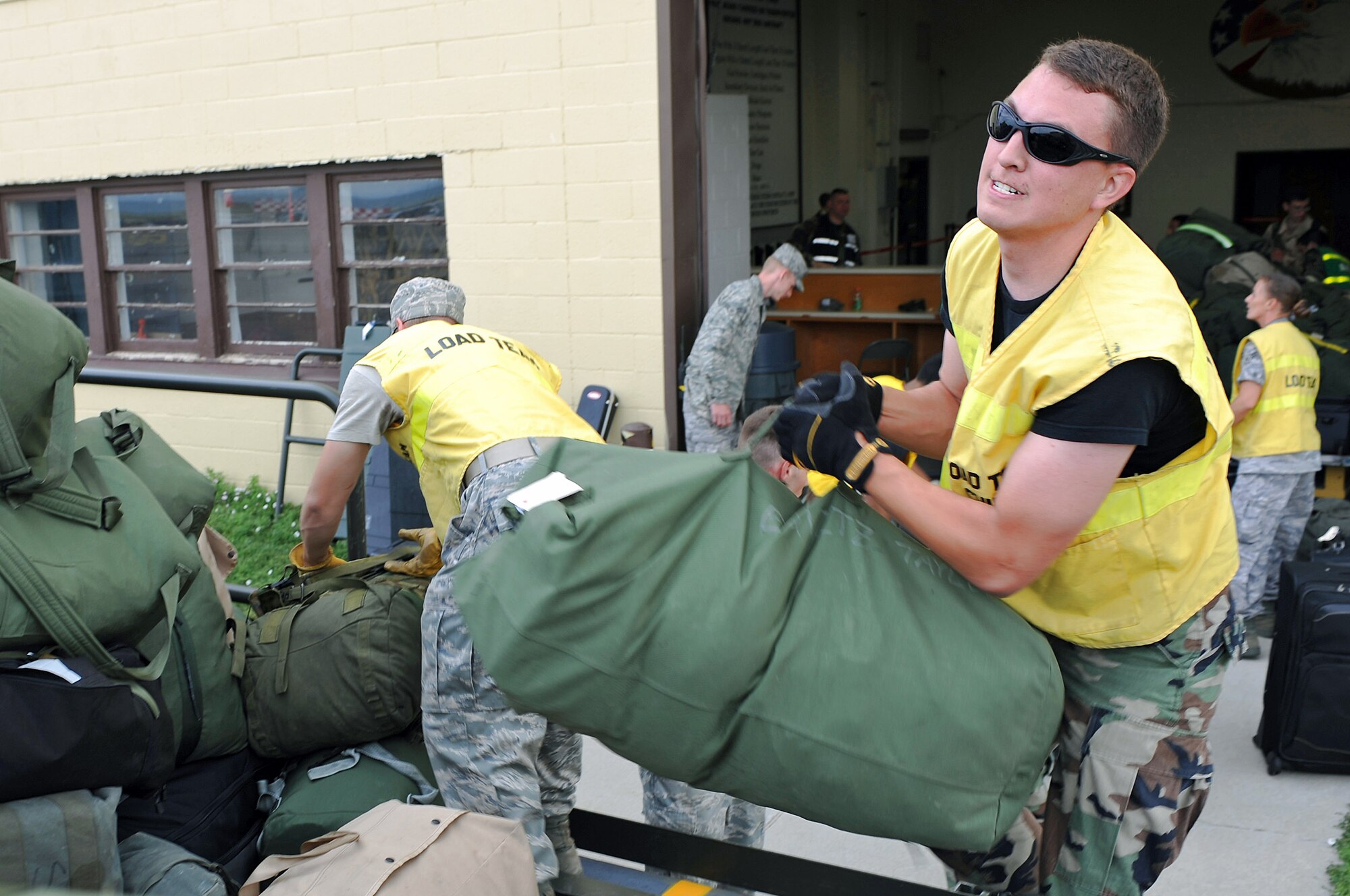 Staff Sgt. Jerry Simmons loads personal and mobility bags of deploying personnel July 22 at Ellsworth Air Force Base, S.D. More than 200 Ellsworth AFB Airmen deployed in support of military operations being conducted in various locations worldwide. Sergeant Simmons is a 28th Civil Engineer Squadron electrical systems craftsman. (U.S. Air Force photo/Senior Airman Marc I. Lane) 