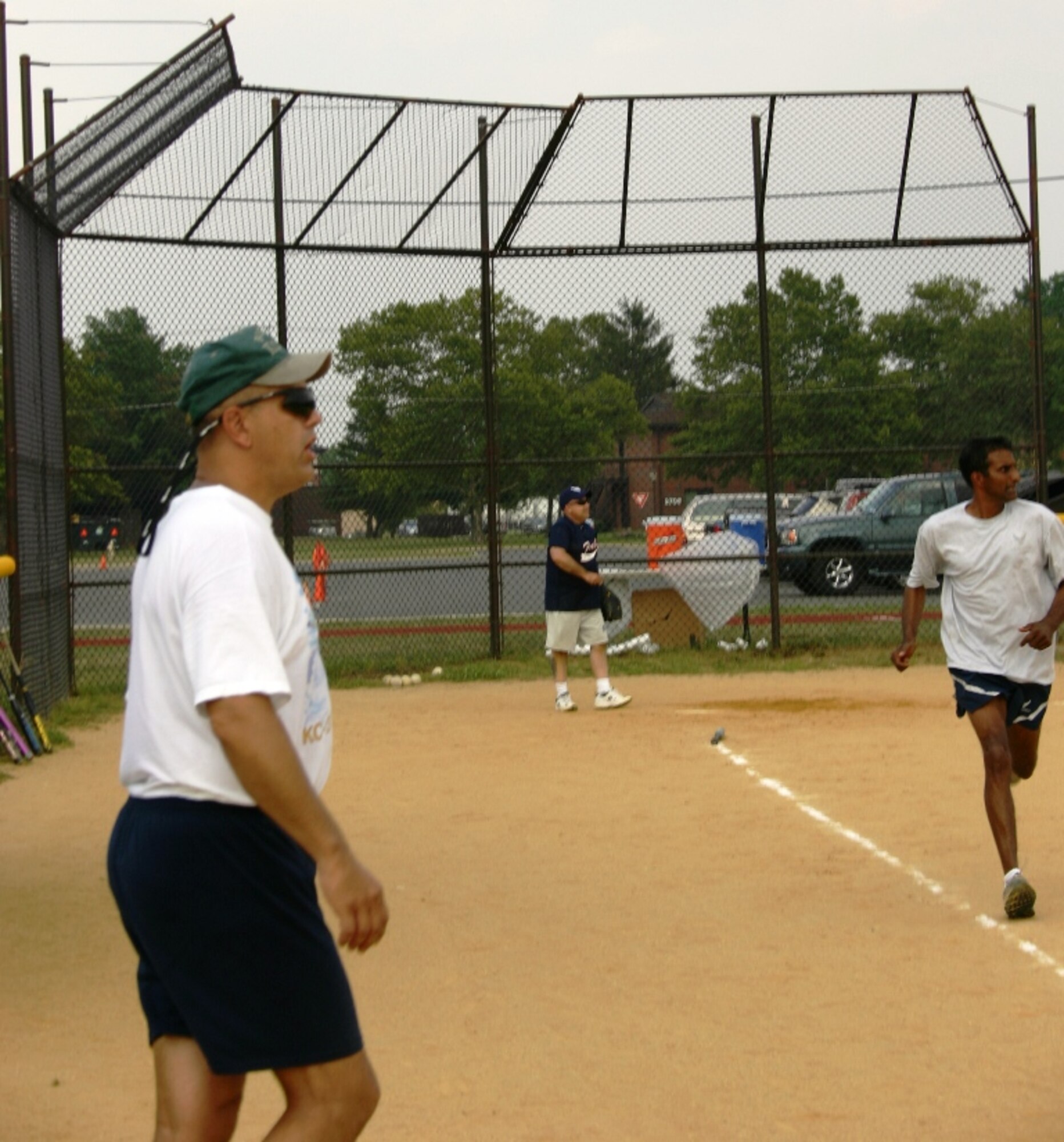 Colonel Balan Ayyar, 305th Air Mobility Wing commander watches his hard-hit ball fall between two out fielders as he runs to first base. The Chief's and Eagles played in a close game on 22 July. The chief's were able to hang on to a one point lead, winning the game 14-13.