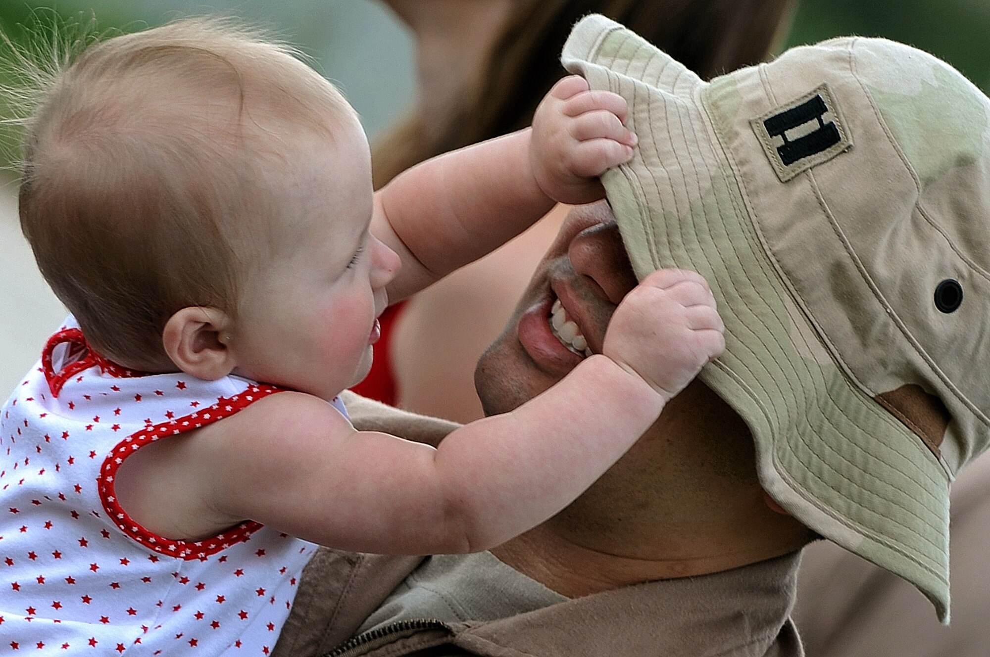 Capt. Steven Fowler holds his 7-month-old daughter, Makenna, before deploying July 22 at Ellsworth Air Force Base, S.D. Captain Fowler, a 34th Bomb Squadron weapons system operator, is deploying to Southwest Asia in support of operations Iraqi Freedom and Enduring Freedom. (U.S. Air Force photo/Senior Airman Marc I. Lane) 
