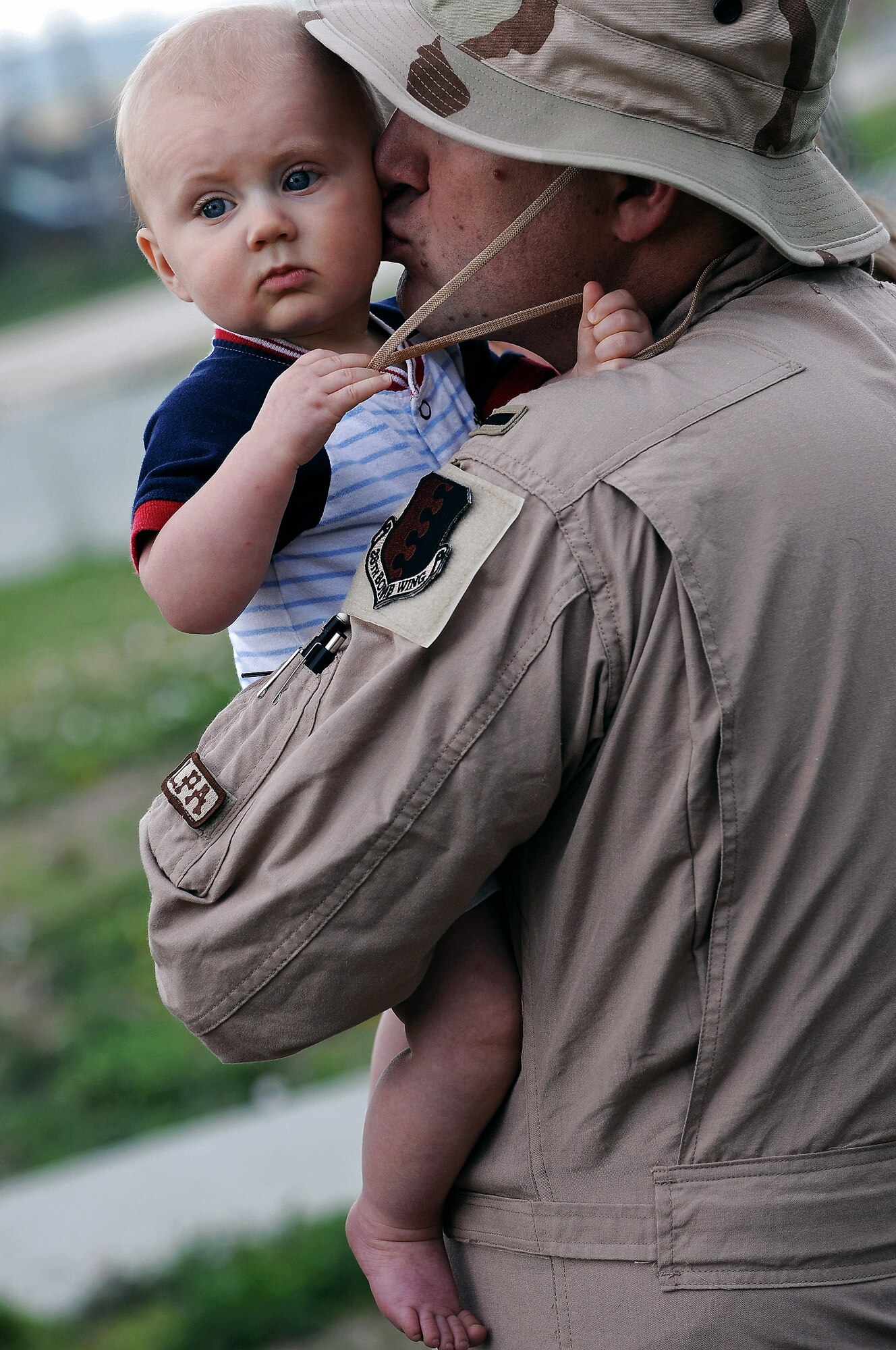 1st. Lt Daniel Silk kisses his 7-month-old son, David, before deploying July 22 at Ellsworth Air Force Base, S.D. Lieutenant Silk, a 34th Bomb Squadron B-1B Lancer pilot, will be deployed to Southwest Asia in support of military operations being conducted in various locations worldwide. (U.S. Air Force photo/Senior Airman Marc I. Lane)