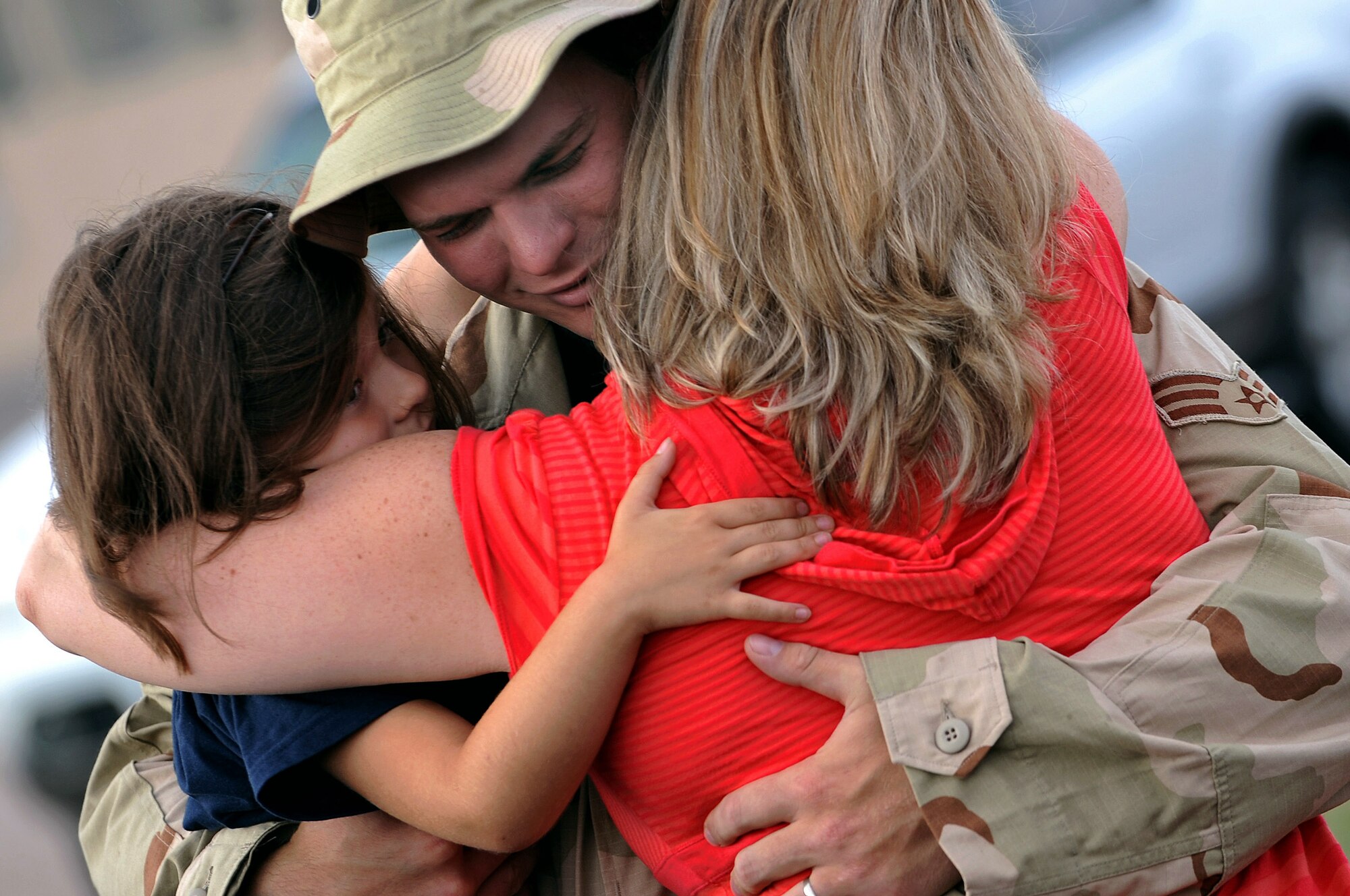 Senior Airman William Seaborne hugs his wife, Shaina, and 5-year-old daughter, Riley, July 22 at Ellsworth Air Force Base, S.D. Airman Seaborne, a 28th Aircraft Maintenance Squadron hydraulic mechanic, will be deployed to Southwest Asia in support of Operations Iraqi Freedom and Enduring Freedom. (U.S. Air Force photo/Senior Airman Marc I. Lane)