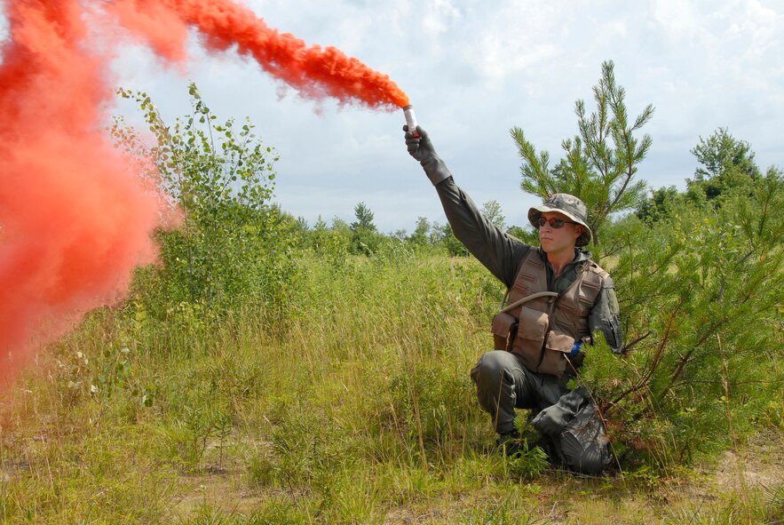 2nd Lt. Paul Borke, an Intelligence Officer for the 115th Fighter Wing in Madison WI, signals his location to an incoming UH-47 Blackhawk helicopter during a practice search and rescue (SAR) mission at Hardwood Range in Juneau County WI on July 16, 2008. As part of the 2008 Patriot Exercise, the SAR mission allowed Air and Army National Guard aircraft to work in tandem to locate, protect, and extract friendly personnel from a potentially hostile environment. (US Air National Guard photo by MSgt Paul Gorman) (RELEASED)