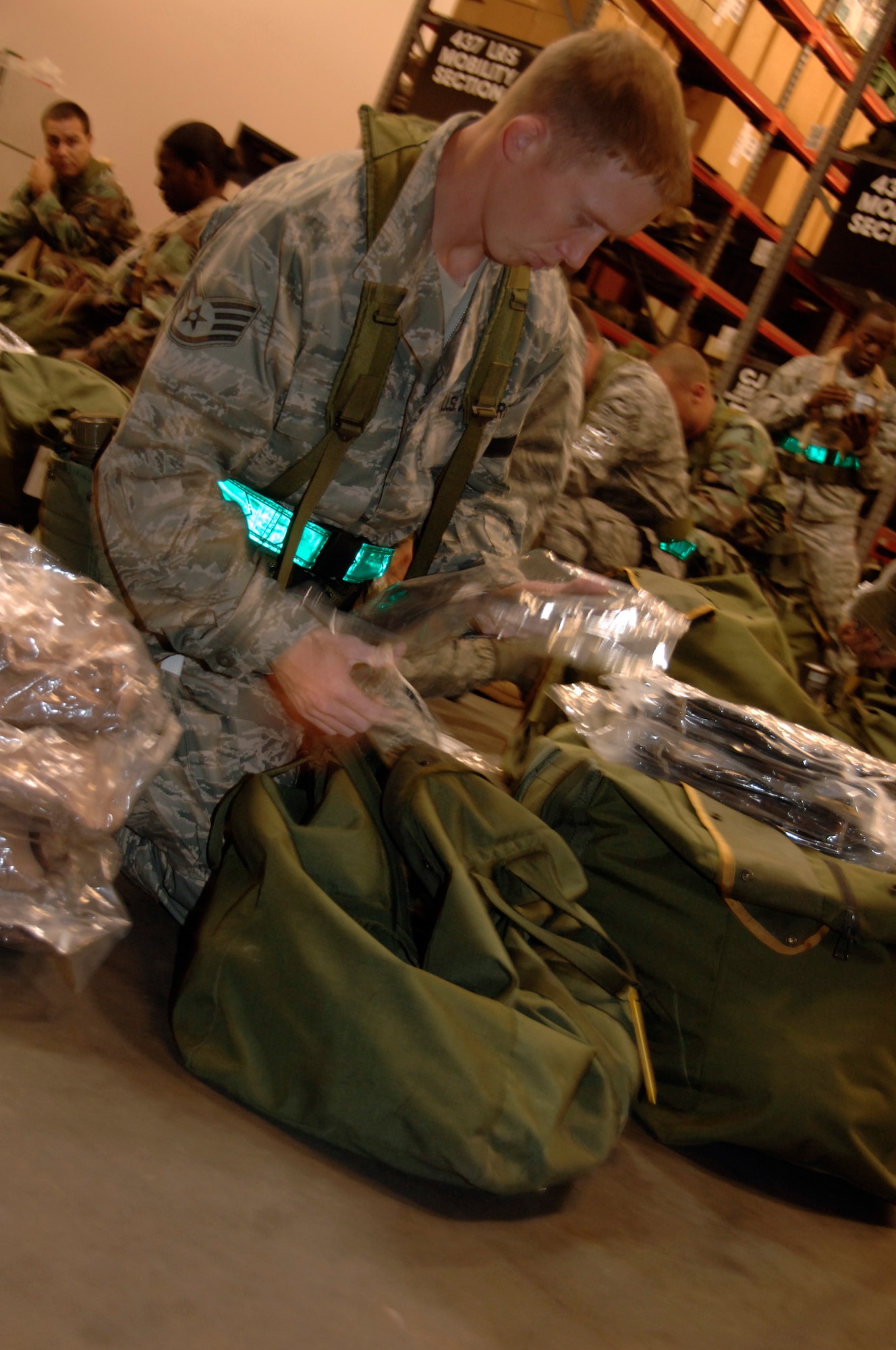 Staff Sgt. John Parker checks his deployment bags during a mobility exercise in the deployment processing center July 22. Airmen arrived at the logistics readiness inspection building to receive a mission briefing and to inspect their deployment bags in preparation for the operational readiness inspection. Sergeant Parker is a paralegal with the 437th Airlift Wing. (U.S. Air Force photo/Airman 1st Class Timothy Taylor)