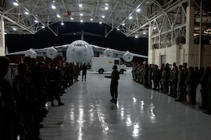 Tech. Sgt. Nina Murphy briefs Team Charleston Airmen after their arrival at a "deployed" location July 22. Nearly 500 Airmen participated in Charleston's last exercise before the Air Mobility Command operational readiness inspection. Sergeant Murphy is a personnelist with the 437th Force Support Squadron. (U.S. Air Force photo/Airman 1st Class Timothy Taylor)