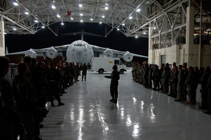 Tech. Sgt. Nina Murphy briefs Team Charleston Airmen after their arrival at a "deployed" location July 22. Nearly 500 Airmen participated in Charleston's last exercise before the Air Mobility Command operational readiness inspection. Sergeant Murphy is a personnelist with the 437th Force Support Squadron. (U.S. Air Force photo/Airman 1st Class Timothy Taylor)