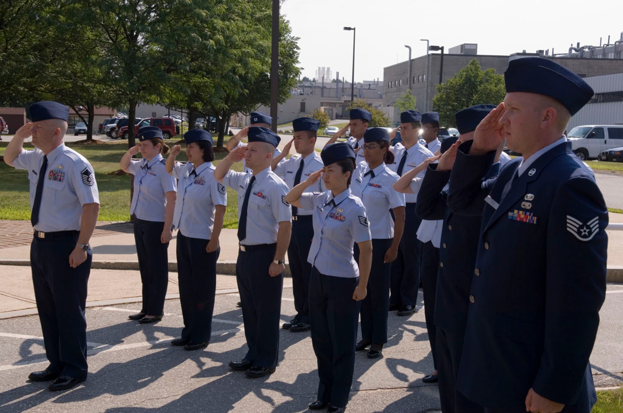 HANSCOM AFB, Mass -- Members of the 66th Comptroller Squadron render salutes during the squadron's change of command ceremony here, July 18. During the ceremony, Maj. Ned June replaced Maj. Robert White as the commander of the squadron. (U.S. Air Force photo by Rick Berry)