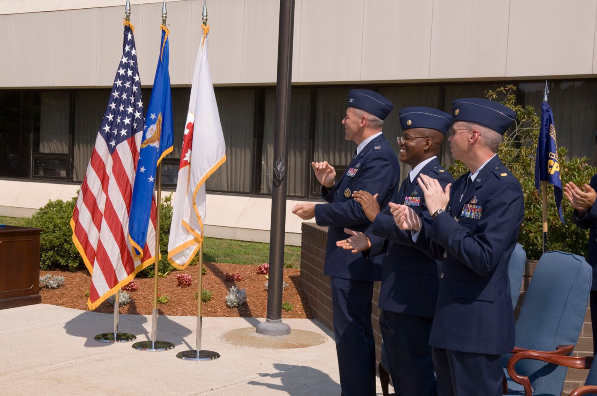 HANSCOM AFB, Mass. -- Col. Tom Schluckebier, Maj. Ned June and Maj. Robert White participate in a change of command ceremony here, July 18. During the ceremony, Colonel Schluckebier, 66th Air Base Wing commander, passed command of the 66th Comptroller Squadron from Major White to Major June. (U.S. Air Force photo by Rick Berry)