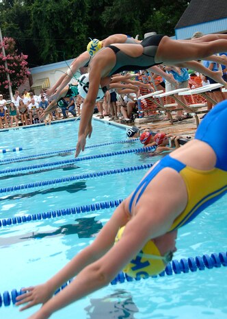 Swimmers launch themselves from the starting ramps at the sound of the buzzer during the 2008 Coastal Carolina Aquatics Association swimming championship at the Jewish Community Center, Charleston, S.C., July 20.  More than 100 children participated in the meet, to include Charleston AFB youths who were part of the Federal Armed Services Team.  (U.S. Air Force photo/Airman 1st Class Timothy Taylor)