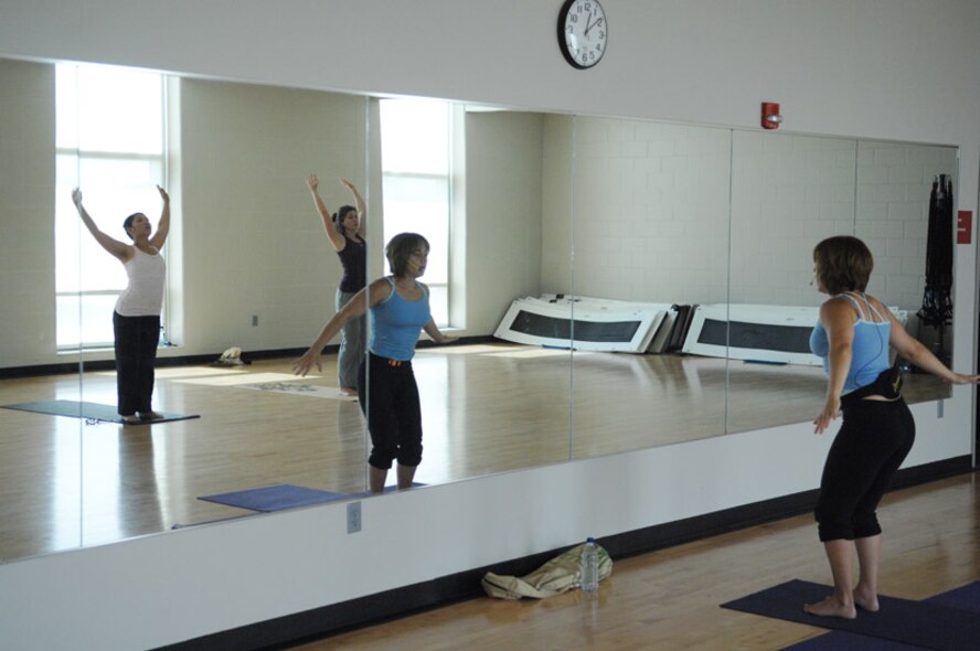MINOT AIR FORCE BASE, N.D. -- Fitness instructor Cheri Charboneau leads a yoga class in a swan dive stretch during the Tuesday morning yoga class here July 15. Yoga is one of the many different classes that are available at the McAdoo Fitness Center every week. For more information on the fitness programs that are available, contact the fitness center at 723-2145. (U.S. Air Force photo by Senior Airman Cassandra Jones)
