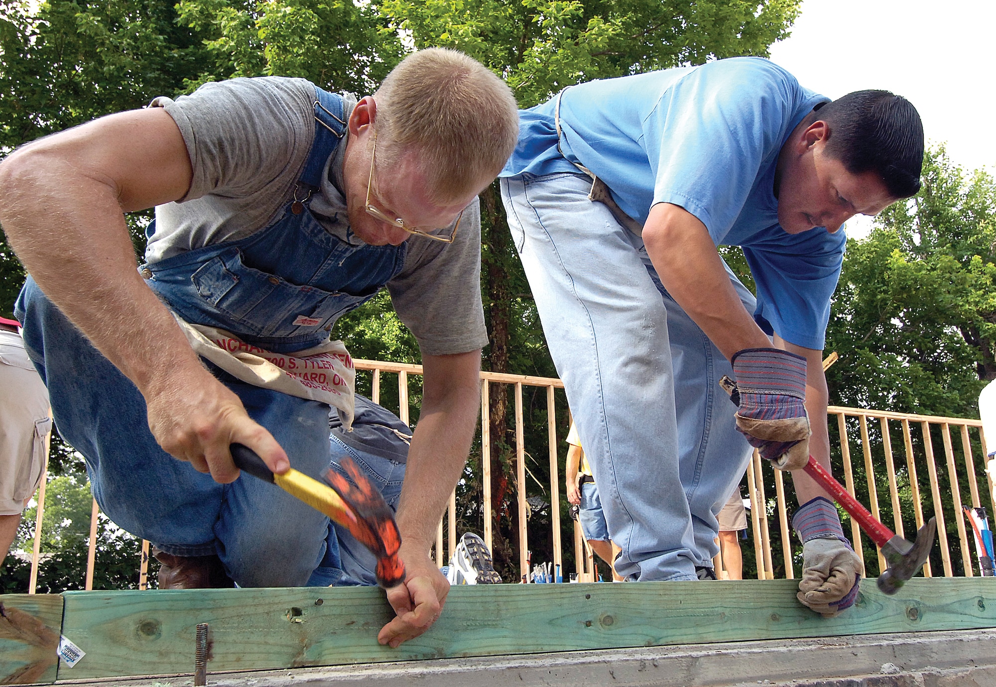 Capt. Justin Erwin, 72nd Operations Support Squadron, left, and Staff Sgt. Jasen Holguin, 349th Recruiting Squadron, work on a sidewall for the Habitat for Humanity home building project.(Air Force photo/Margo Wright)