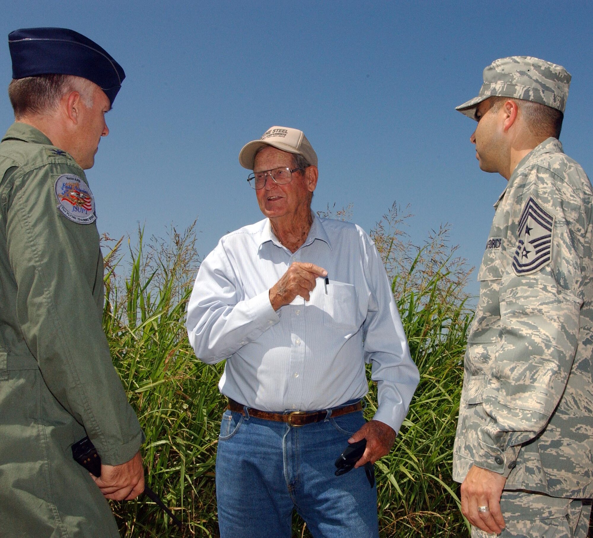 Bob Klemme, center, tells Col. Richard Murphy, the 71st Flying Training Wing vice commander, left, and Chief Master Sgt. Ruben Gonzalez, 71st FTW command chief, about the day-to-day hardships of cowboys driving cattle along the historic Chisholm Trail. Mr. Klemme plans to place a trail marker along the south side of Vance AFB where the trail crosses onto base property. (U.S. Air Force photo by Joe B. Wiles)