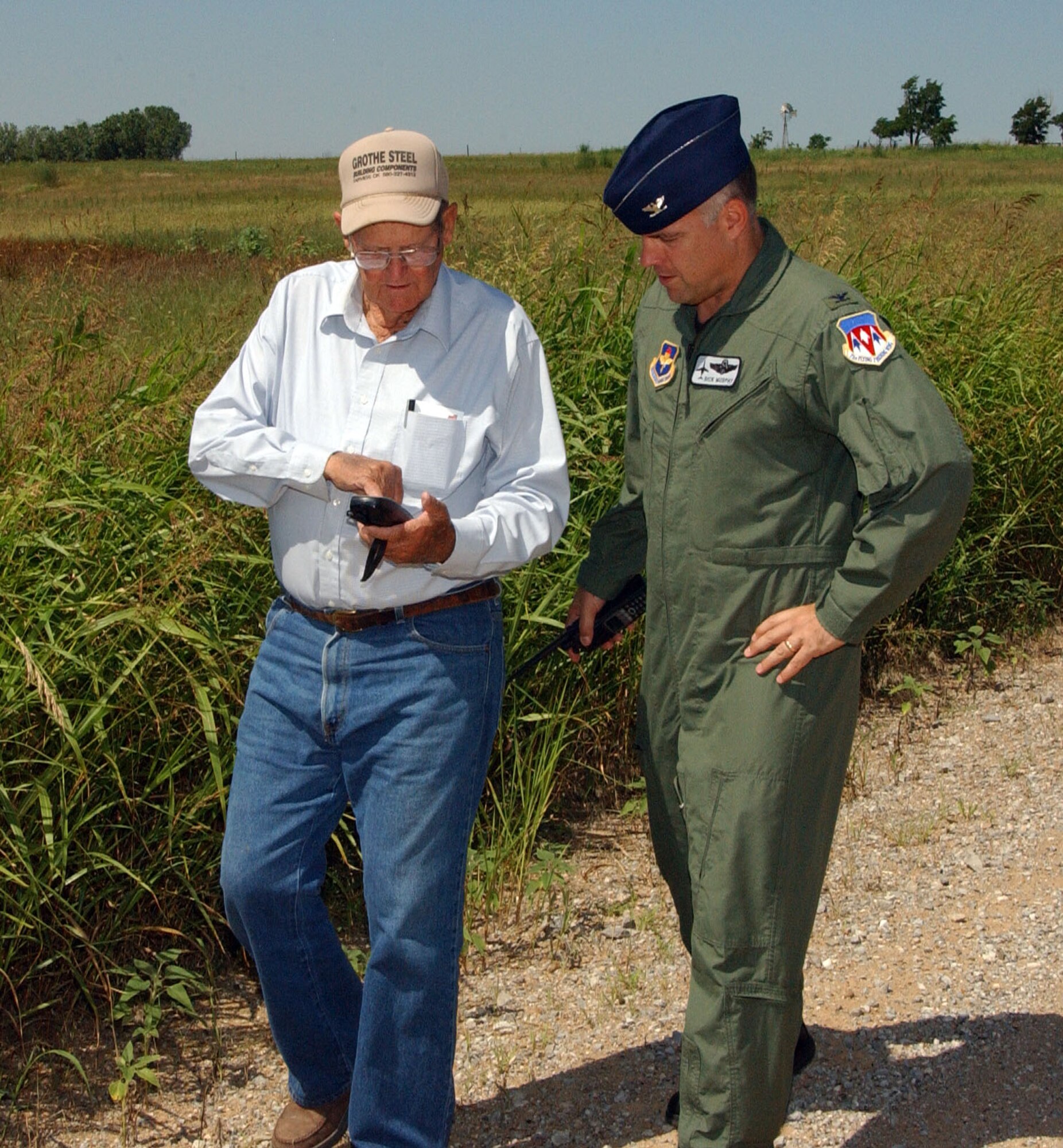 Bob Klemme, left, shows Col. Richard Murphy, the 71st Flying Training Wing vice commander, the Global Positioning System coordinates where the historic Chisholm Trail crosses onto Vance AFB along the southern edge of the base. Mr. Klemme has placed 400 concrete markers along the trail throughout Oklahoma.  (U.S. Air Force photo by Joe B. Wiles)
