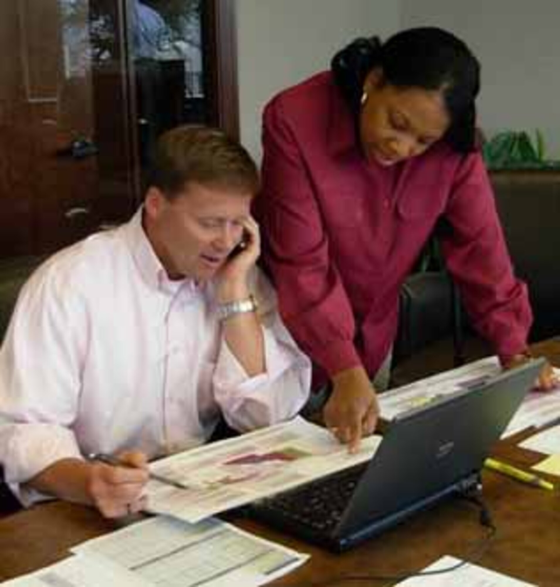 Tinker's Housing Privatization Program Manager, Carol Hill and Barrett Larwin, Region vice president for Belfour Beatty Communities finalize real estate transaction documents in Denver, Colo. prior to closing the AMC West Housing Privatization project on July 21.
(Courtesy Photo – U.S.  Air Force)
