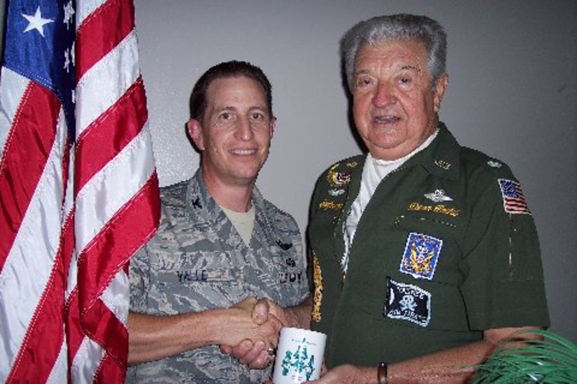 Flight Captain Dean Todd, presents a Daedalian mug at the Daedalian's quarterly meeting to Col. Christopher Valle, 81st Training Wing vice commander for achievements during his Air Force career and flight experience.  Col. Valle was the guest speaker at the meeting. The Order of the Daedalians is a national fraternity of military pilots. The colonel's speech focused on his background and the future of the Air Force.  (Photo by Joe Nastasi)