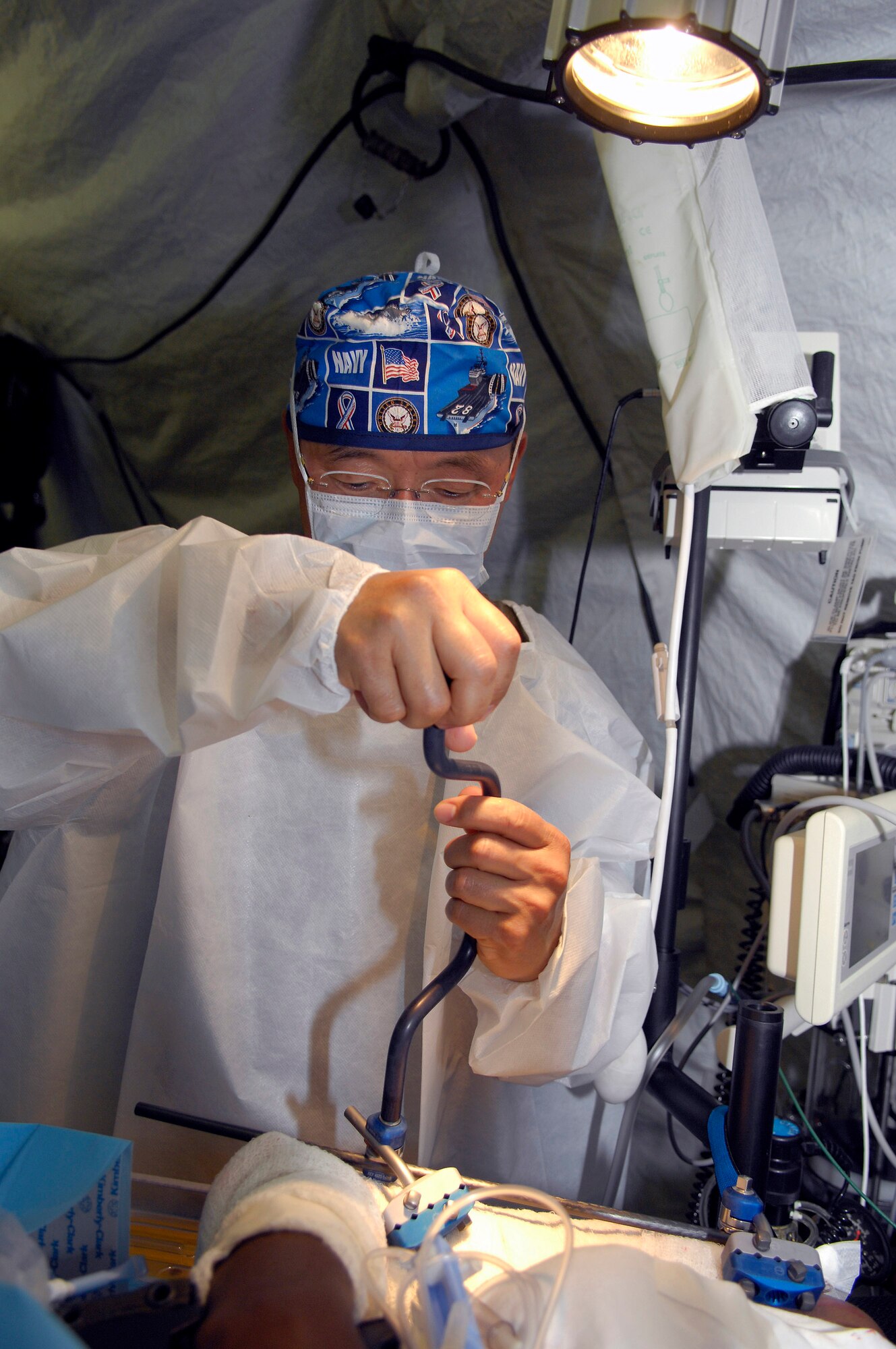 U.S. Navy Capt. William Oh simulates an operation on a Malian patient July 18 during a mass casualty exercise at Bamako, Mali. More than 90 servicemembers deployed to MEDFLAG 08, a multi-national medical training exercise designed to enhance medical capabilities and readiness for U.S. and African forces. Captain Oh is deployed from Naval Operational Support Unit, Toledo, Ohio. (U.S. Air Force photo/Senior Airman Michael S. Dorus) 
