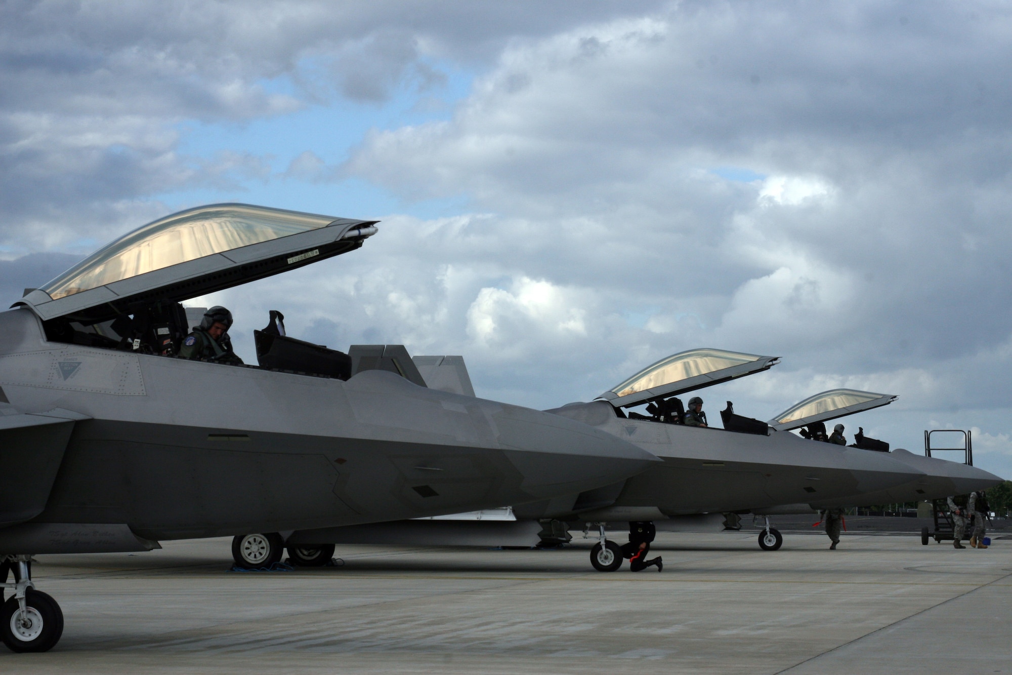 Maj. Paul Moga, Capt. Leo Lemelson and Flt Lt. Dan Robinson arrive at RAF Fairford July 8.  The F-22 Demonstration Team conducted the first trans-Atlantic deployment this month to support the Royal International Air Tattoo and the Farnborough International air show held in England.  (U.S. Air Force photo by 2nd Lt. Georganne E. Schultz)