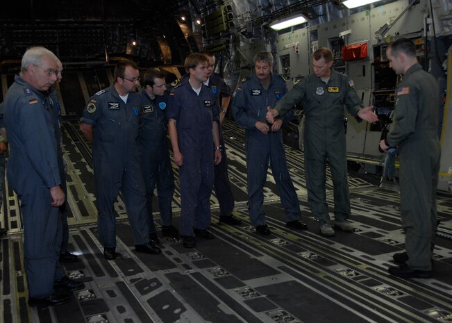 Col. John "Red" Millander briefs German Generalmajor Ahrens Hans-Werner and his crew inside a C-17 on Charleston AFB flightline July 21. The German general visited Charleston AFB for an orientation of the C-17 and to gain greater knowledge of the capabilities of the aircraft. General Hans-Werner is the commander of the German Air Force Air Transport Command and Colonel Millander is the 437th Airlift Wing commander. (U.S. Air Force photo/Airman 1st Class Katie Gieratz)