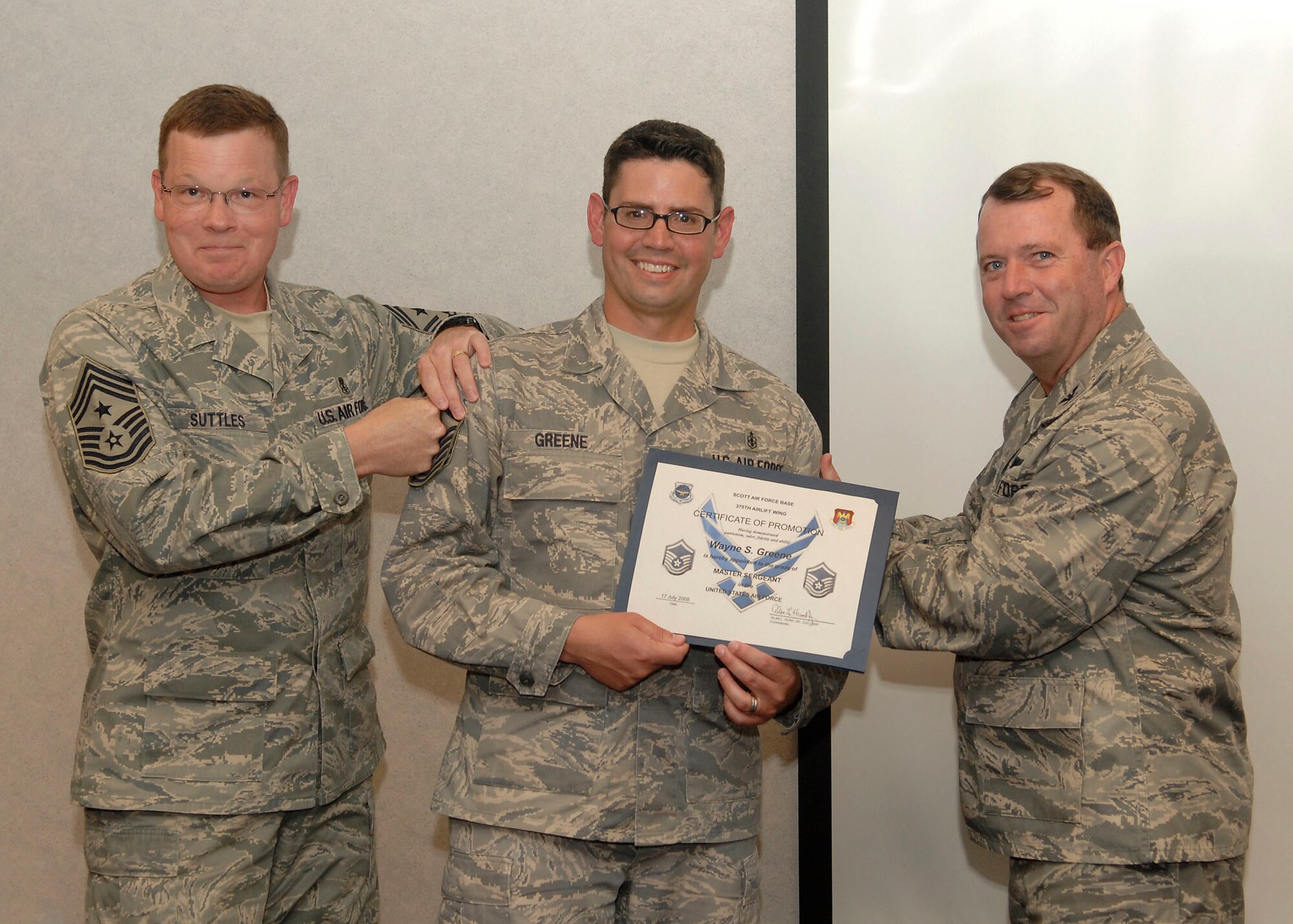 SCOTT AIR FORCE BASE, Ill. -- Chief Master Sgt. Jim Suttles, 375th Airlift Wing command chief and Col. Al Hunt, 375th Airlift Wing commander, promote Tech. Sgt. Scott Greene, First Term Airman Center NCOIC, to master sergeant Friday. Sergeant Greene was promoted through the Stripes for Exceptional Performers program. STEP promotions are limited, less than 200 slots are released annually Air Force-wide. 
(US Air Force photo/Airman 1st Class Megan Gilliland)