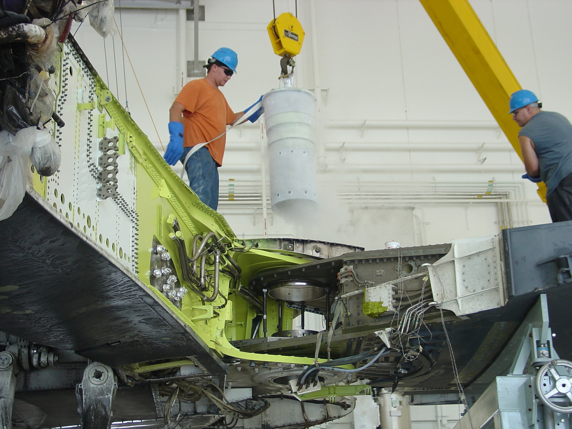 Tinker members installed a new wing pin to attach the B-1 wing to the aircraft. The wing pin must be frozen with liquid nitrogen for insertion. (Air Force photo/Brian Koehl) 
