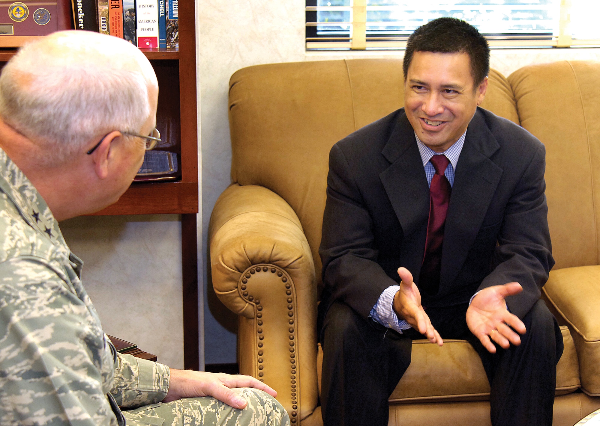 Tinker mechanical engineer Bang Nguyen visits with Oklahoma City Air Logistics Center Commander, Maj. Gen. Loren Reno after learning  they share a defining moment of history.  More than thirty years ago, thousands of miles away,  Gen. Reno was  a young Airman helping evacuate American and Vietnamese families as Saigon was falling to the communists.   Mr . Nguyen was 18, urged to flee his homeland with two younger siblings and only the clothes they were wearing.  The two men recalled their shared experiences recently during a brief visit in the commander’s office.(Air Force photo/Margo Wright)