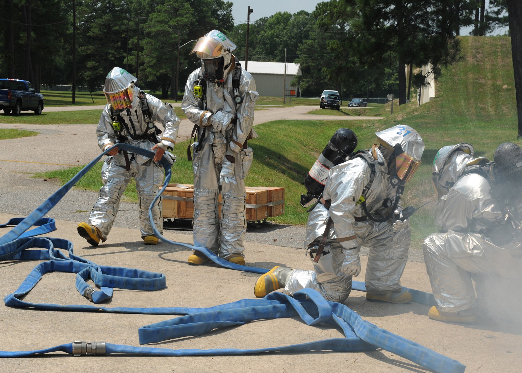 SEYMOUR JOHNSON AIR FORCE BASE, N.C. - Firemen from the 4th Civil Engineer Squadron, move quickly to extinguish a fire as part of the Munitions Major Accident Response Exercise here, July 21. The purpose of the MARE is to exercise first responder?s timely reaction in the event of a real world situation.  (U.S. Air Force photo by Airman 1st Class Whitney S. Stanfield)