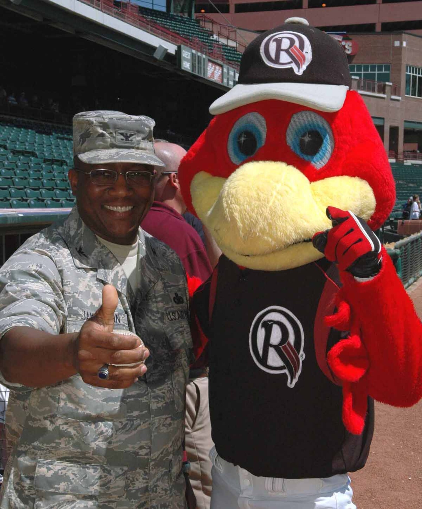 Col. Allen Jamerson, 72nd Air Base Wing commander, poses for a photograph with Rowdy RedHawk prior to throwing out the ceremonial first pitch to start the Oklahoma City RedHawks’ AAA baseball game with the Memphis Redbirds on Monday. The RedHawks hosted several on-base leaders during the game as part of a community outreach event. The Redbirds defeated the RedHawks, 6-1, behind a brilliant pitching performance by former RedHawk John Wasdin. Wasdin threw seven perfect innings before allowing a leadoff home run to Chris Shelton in the eighth. (Air Force photo/Darren D. Heusel)