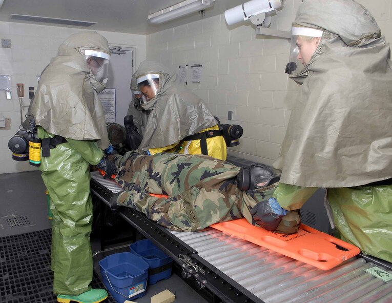 OSAN AIR BASE, Republic of Korea -- Members of the 51st Medical Group decontamination team prepare to decon an “injured” Airman following a simulated chemical attack during exercise Beverly Bulldog 08-03 July 22. The hard-sheltered, in-place decontamination facility is the only one of its kind in the entire Air Force. (U.S. Air Force photo/Staff Sgt. Scottie McCord)