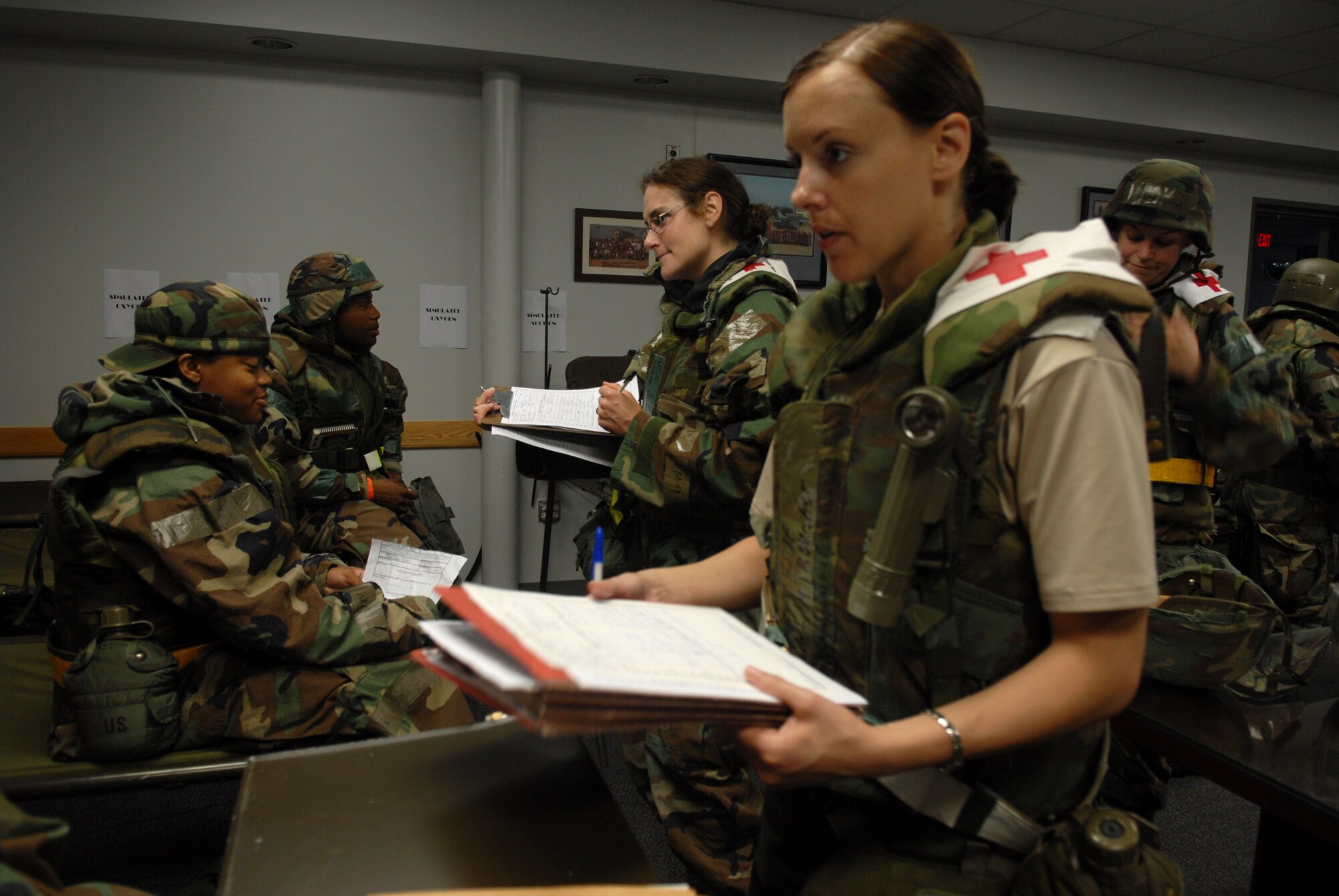 KUNSAN AIR BASE, REPUBLIC OF KOREA -- Staff Sergeant Jennifer Boucher, public health technician, and Captain Brigitte French, public health officer,8th Medical Group(MDG), interview patients about a possible food outbreak while Airmen of the 8th MDG treat other patients during the BEVERLY BULLDOG 08-03 peninsula  wide operational readiness exercise (PENORE) here July 23. The PENORE is a training exercise among United States Forces in Korea, keeping Wolf Pack Airmen and the 8th Medical Group ready to execute the mission. (U.S. Air Force photo by: Senior Airman Angela Ruiz)