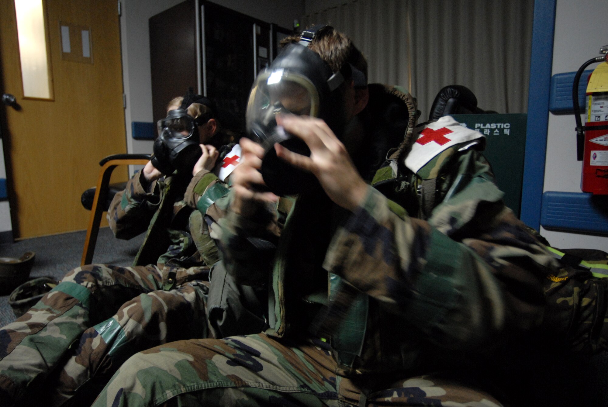 KUNSAN AIR BASE, REPUBLIC OF KOREA -- Senior Airman Jeffrey Bolles, aerospace medical technician, and Senior Airman Wendy Lloyd, heath service technician, 8th Medical Group, Remove there protective masks (gas mask) during the BEVERLY BULLDOG 08-03 peninsula  wide operational readiness exercise (PENORE) here July 23. The PENORE is a training exercise among United States Forces in Korea, keeping Wolf Pack Airmen and the 8th Medical Group ready to execute the mission. (U.S. Air Force photo by: Senior Airman Angela Ruiz)