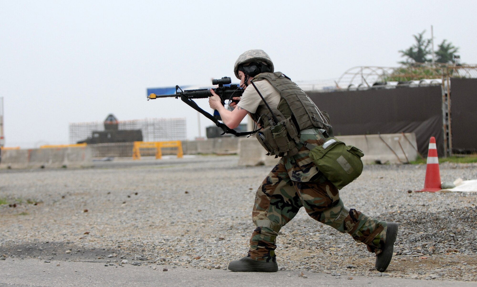 KUNSAN AIR BASE, Republic of Korea -- Senior Airman Christopher Pipkin, 8th Security Forces Squadron, bounds forward while attempting to secure a building after an enemy attack here July 23.  The attack is a part of the peninsula wide operational readiness exercise being conducted here to evaluate the wing’s readiness and ability to perform its wartime mission.  (U.S. Air Force photo/TSgt Quinton T. Burris)