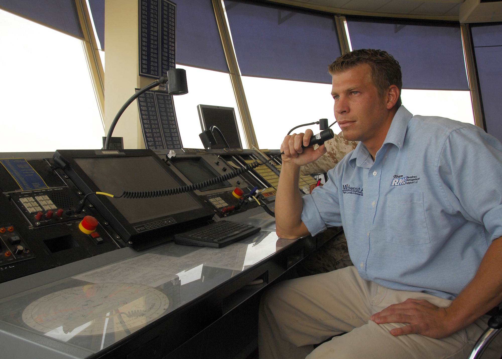 SOUTHWEST ASIA -- Max Geesey, an Air Traffic Control Tower liaison assigned to the 386th Expeditionary Operation Support Squadron, calls in landing instructions from the airfield tower to a C-130 on July 19 at a base in Southwest Asia. Mr. Geesey works with host nation Air Traffic Controllers to safely ensure more than 2,000 takeoffs and landings per month are handled without incident. (U.S. Air Force photo/Tech. Sgt. Raheem Moore)