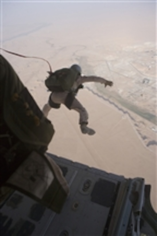 A U.S. Marine from 3rd Reconnaissance Battalion, Regimental Combat Team 5 exits an aircraft during a static line combat jump over Al Asad, Iraq, on July 16, 2008.  