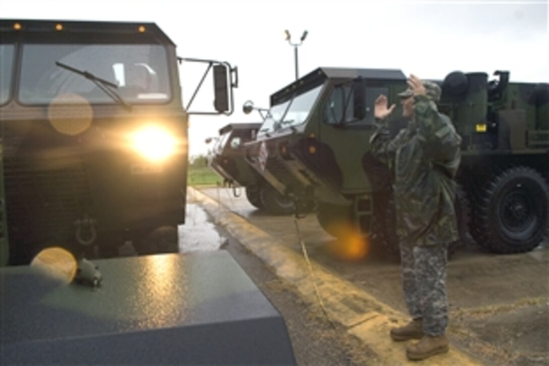 U.S. Army Sgt. 1st Class Jeff Printy marshals in nine light-medium tactical vehicles deployed from San Antonio to the Standing Joint Inter-Agency Task Force headquarters at the National Guard Armory, Weslaco, Texas, in anticipation of heavy flooding from Hurricane Dolly, July 22, 2008. 

