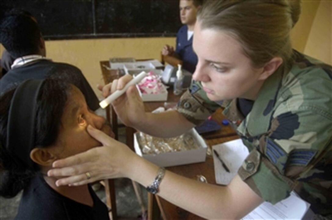 U.S. Air Force Senior Airman Kate Thomas, attached to the Military Sealift Command hospital ship USNS Mercy (T-AH 19), examines a patientís retina as part of a medical civic action program in Timor Leste on July 21, 2008.  The hospital ship, which is deployed in support of Pacific Partnership 2008, a humanitarian and civil assistance mission, is also scheduled to visit Papua New Guinea and Micronesia.  