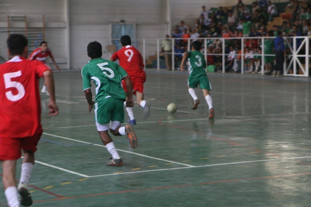 RAMADI, Iraq (July 23, 2008) - Teenagers from various Ramadi neighborhoods play a game of soccer during the Ramadi Youth Conference July 23. The event was considered a tremendous success for the region. The children all agreed the event was exciting and were constantly asking the planners when the next conference would take place. “I had a real good time,” said Mahmod Gumal, a 14-year-old boy that can speak and understand English. “I learned a lot while also being to spend time with my friends and watch a few soccer games. I hope they will do another conference again soon.” (Official U.S. Marine Corps photo by Lance Cpl. Casey Jones) (RELEASED)