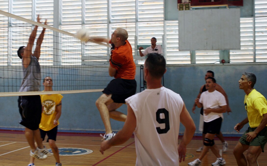 Ryan Wassink, Aches and Pains 2's left forward, goes head to head spiking a ball down on Ben Duong during a 2008 Intramural Volleyball League game at the gymnasium July 24 here.