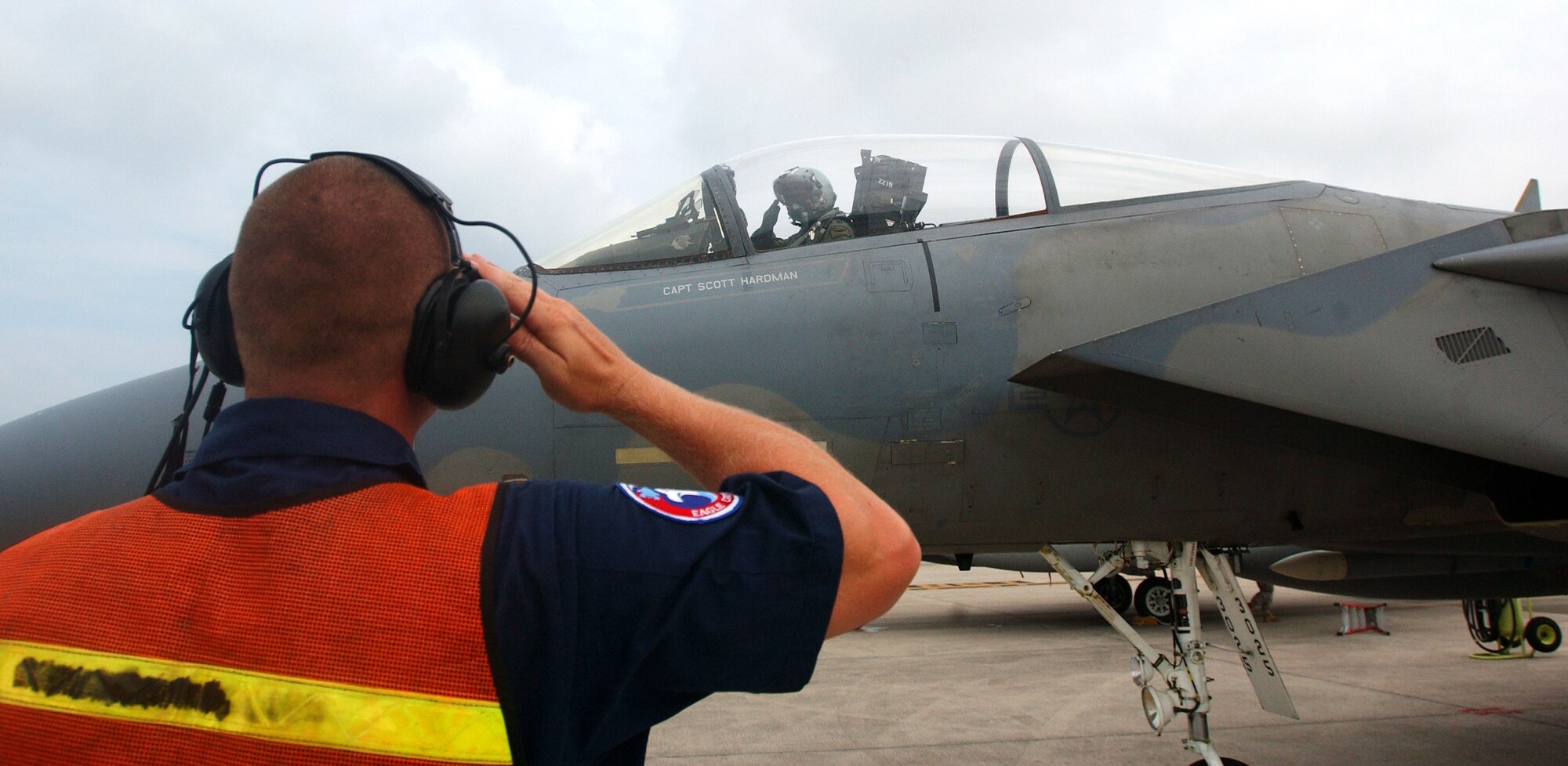Staff Sgt. Allan King, crew chief from the 67th Aircraft Maintenance Unit, gives a last salute to the pilot before takeoff July 23, Kadena Air Base, Japan.   (U.S. Air Force photo/Tech. Sgt. Rey Ramon)    