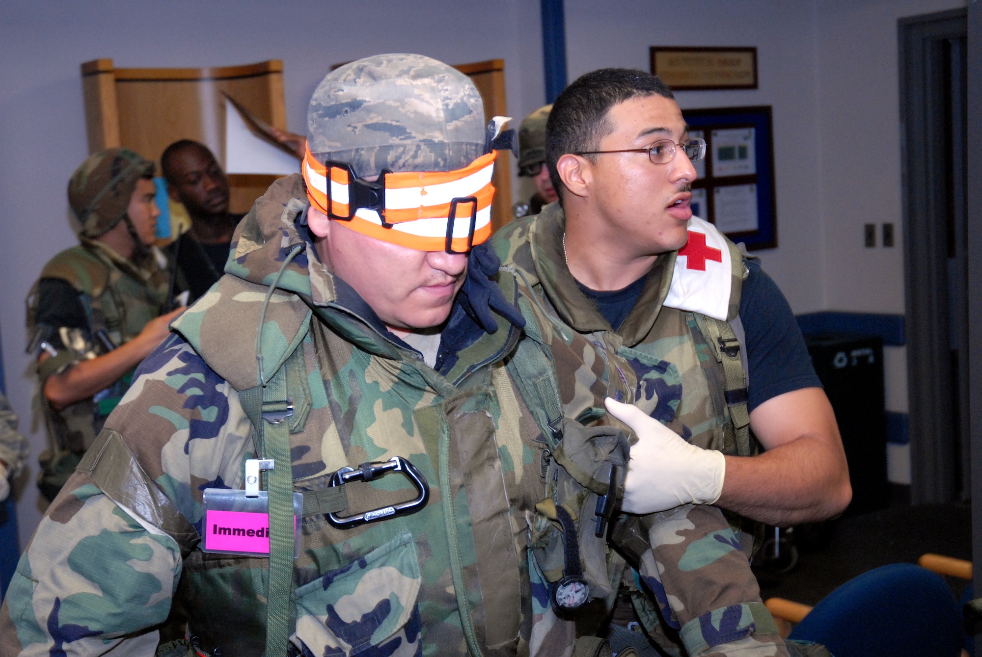 KUNSAN AIR BASE, REPBULIC OF KOREA -- Senior Airman Cecil Lozana, 8th Medical Group Medical Technician, escorts an attack victim to a bed during the BEVERLY BULLDOG 08-03 peninsula wide operational readiness exercise here July 23. Kunsan is participating in the PENORE to evaluate its readiness and ability to perform its wartime mission. (U.S. Air Force photo/Staff Sgt. Jason Colbert)