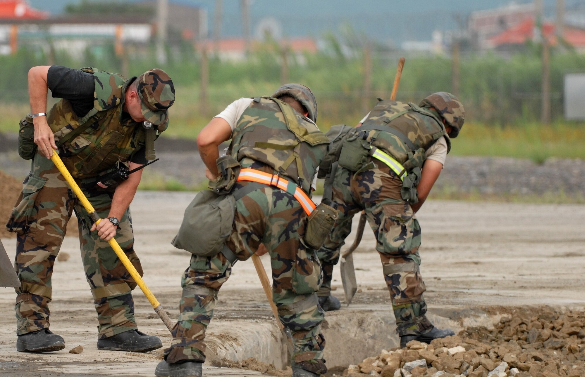 KUNSAN AIR BASE, Republic of Korea -- Members of the 8th Civil Engineer Squadron Rapid Runway Repair team work to restore the runway during a peninsula wide operational readiness exercise scenario here July 24.  Kunsan is participating the PENORE to evaluate the wing’s readiness and ability to perform its wartime mission.  (U.S. Air Force photo/TSgt Quinton T. Burris)