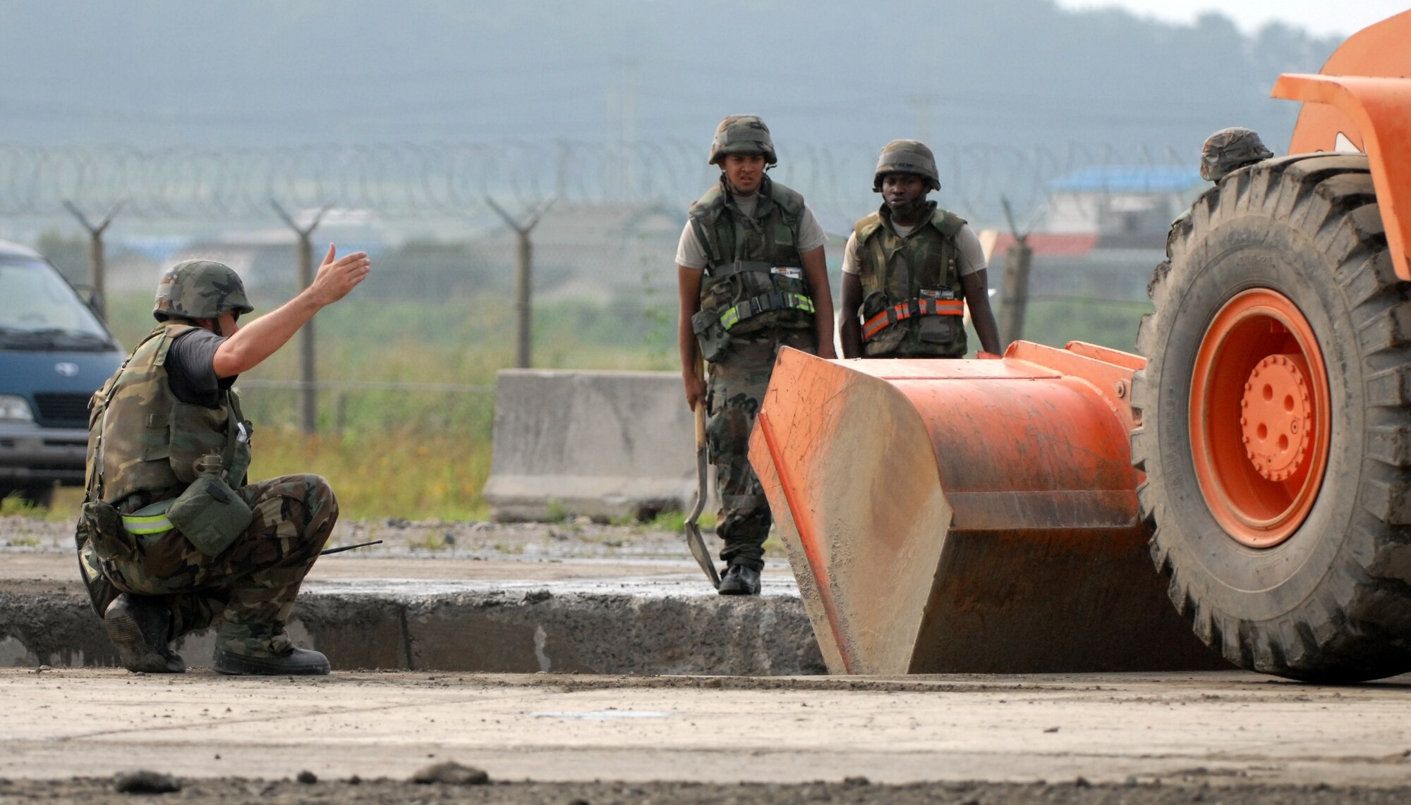 KUNSAN AIR BASE, Republic of Korea -- Staff Sgt. Vincent Vargas and Airmen First Class Gommels Robert and Troy Ross, members of the 8th Civil Engineer Squadron Rapid Runway Repair team work to restore the runway during a peninsula wide operational readiness exercise scenario here July 24.  Kunsan is participating the PENORE to evaluate the wing’s readiness and ability to perform its wartime mission.  (U.S. Air Force photo/TSgt Quinton T. Burris)